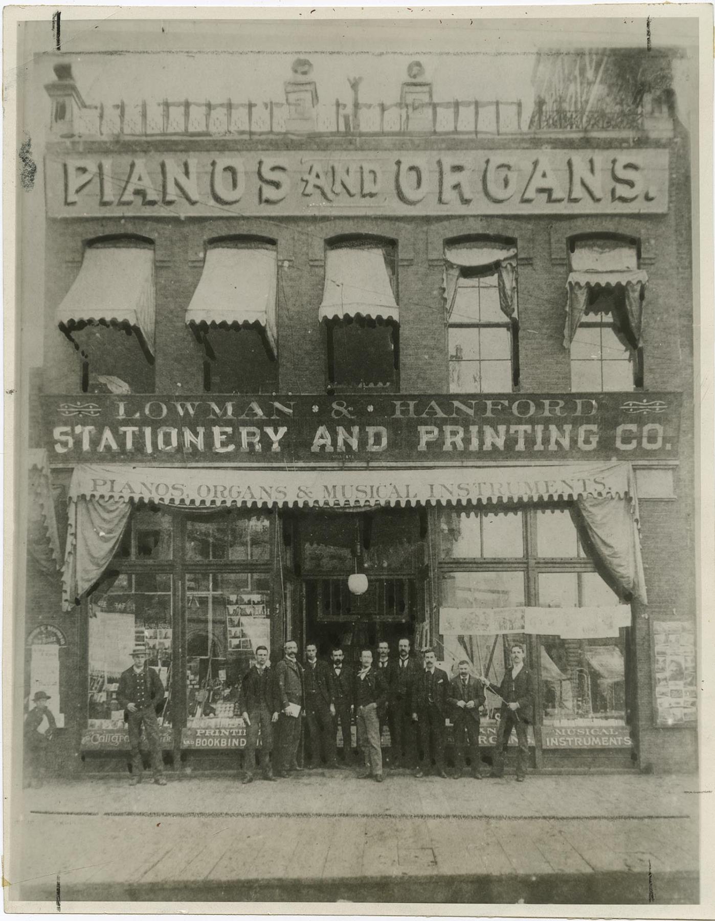 Image of Employees posing outside Lowman & Hanford Co. building on First and Cherry, Seattle, 1888