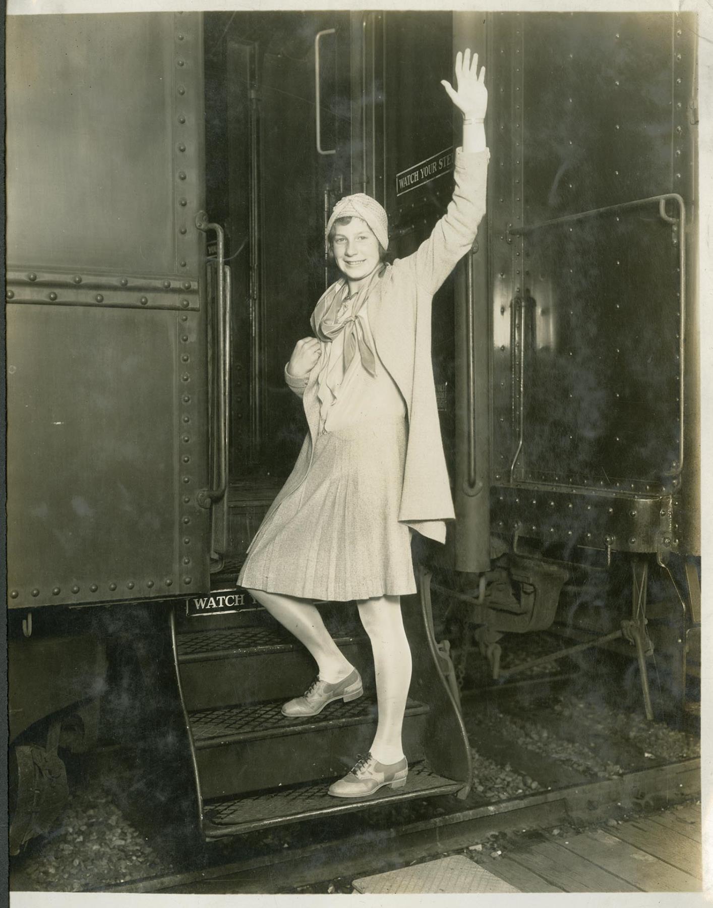 Image of Helene Madison waving from train steps, circa 1929