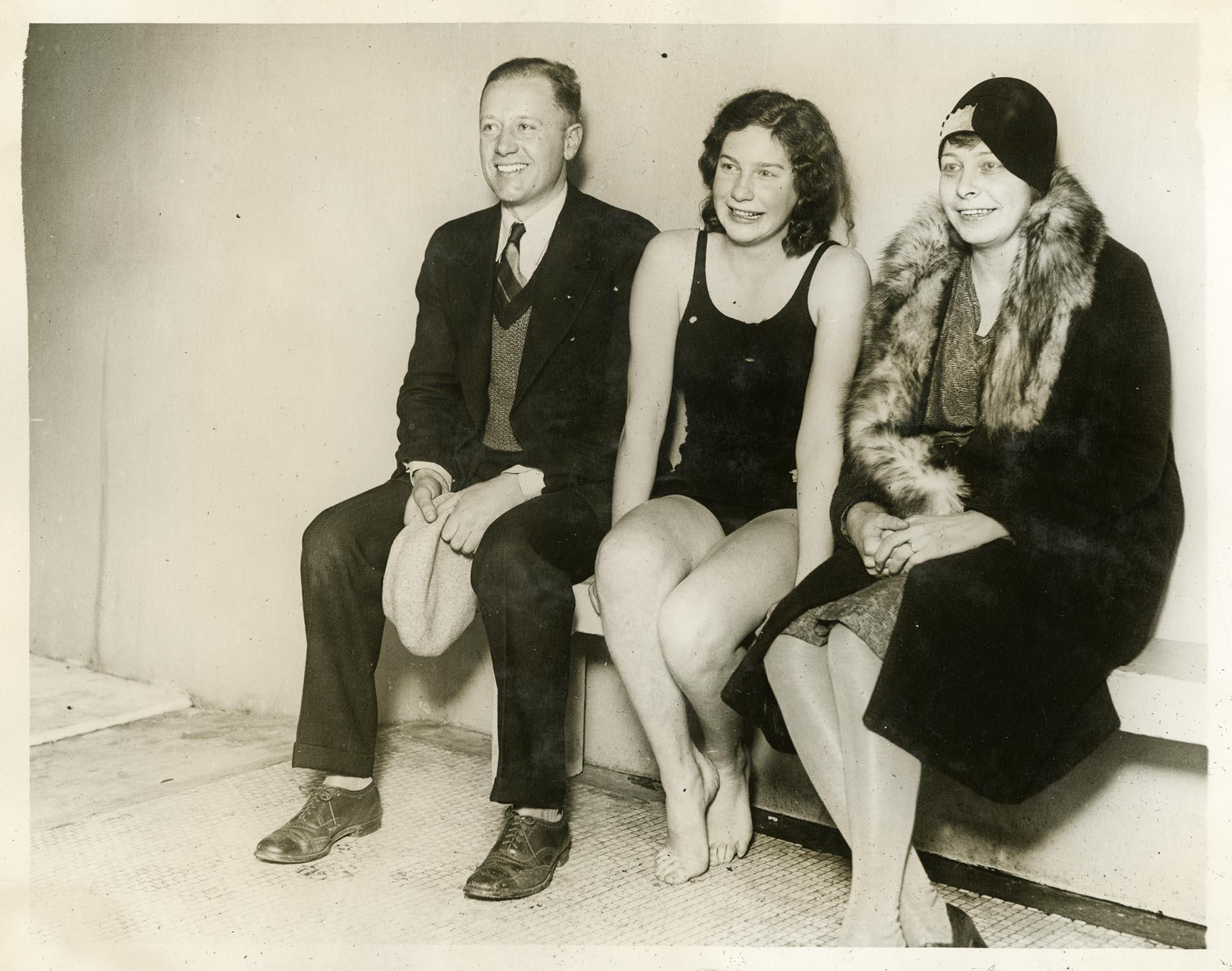 Image of Helene Madison sitting with coach Ray Daughters and her mother at the Moore Hotel pool, circa 1929