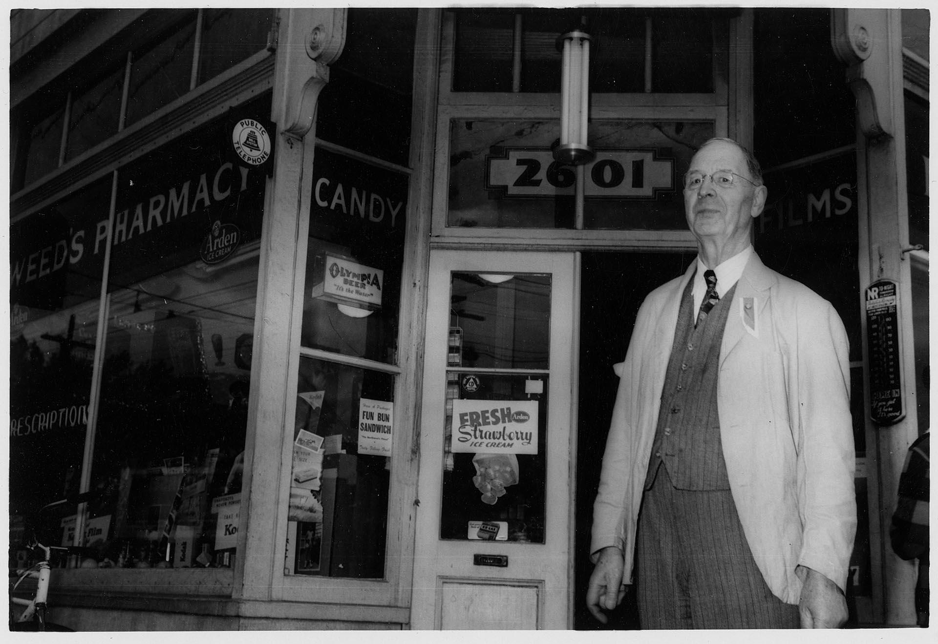 Image of Bert Weed in front of Weed's pharmacy, Seattle, July 3, 1952