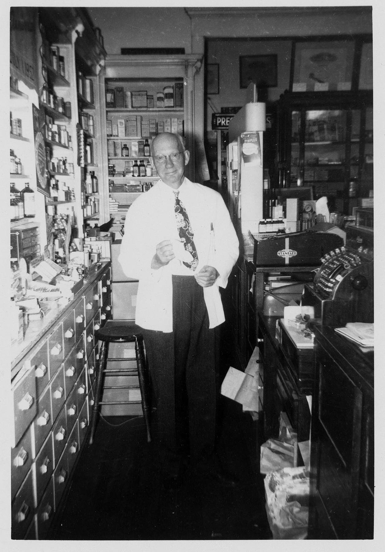 Image of Bert Weed inside Weed's pharmacy, Seattle, July 3, 1952