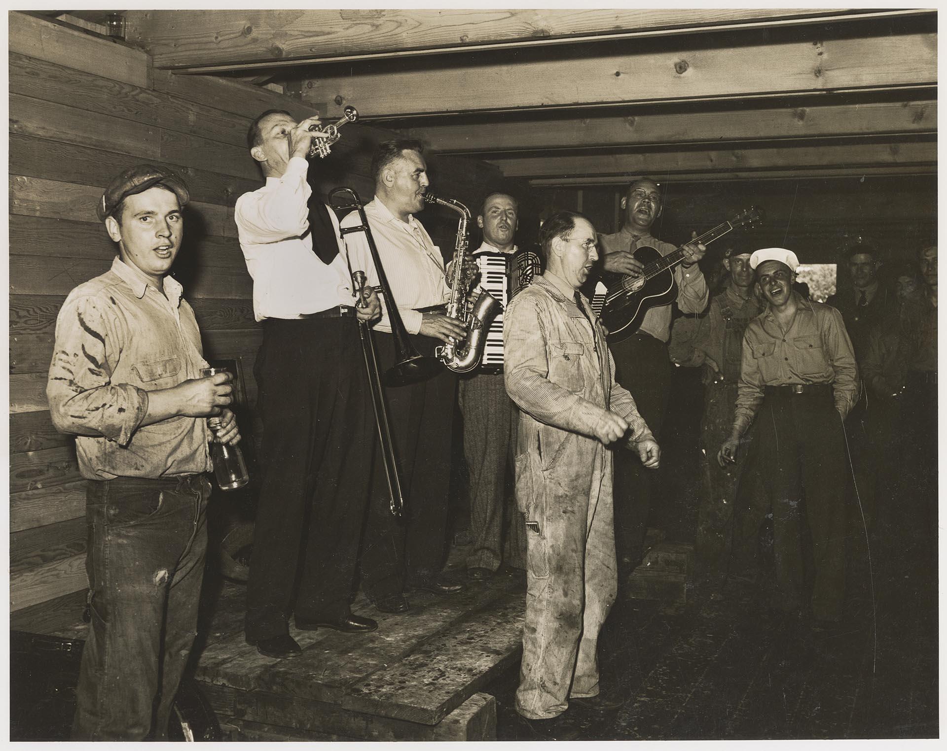 Image of Yard workers and band celebrating launch at Olson & Winge Marine Works yard, Seattle, June 1944