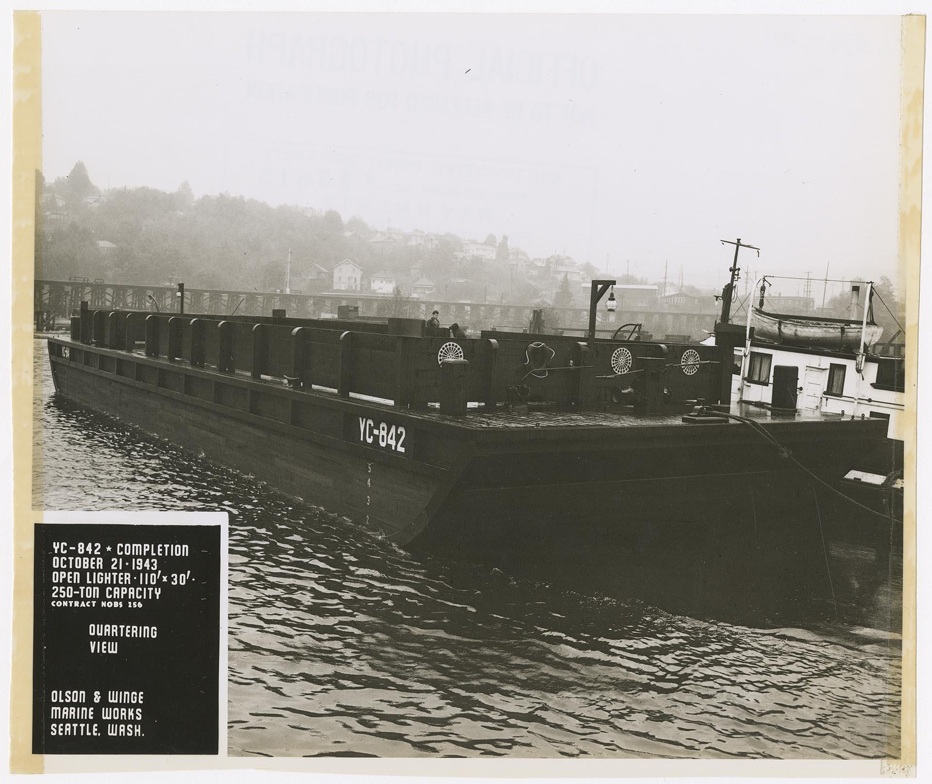 Image of Open lighter YC-842 in water near the Olson & Winge Marine Works yard, Seattle, October 21, 1943