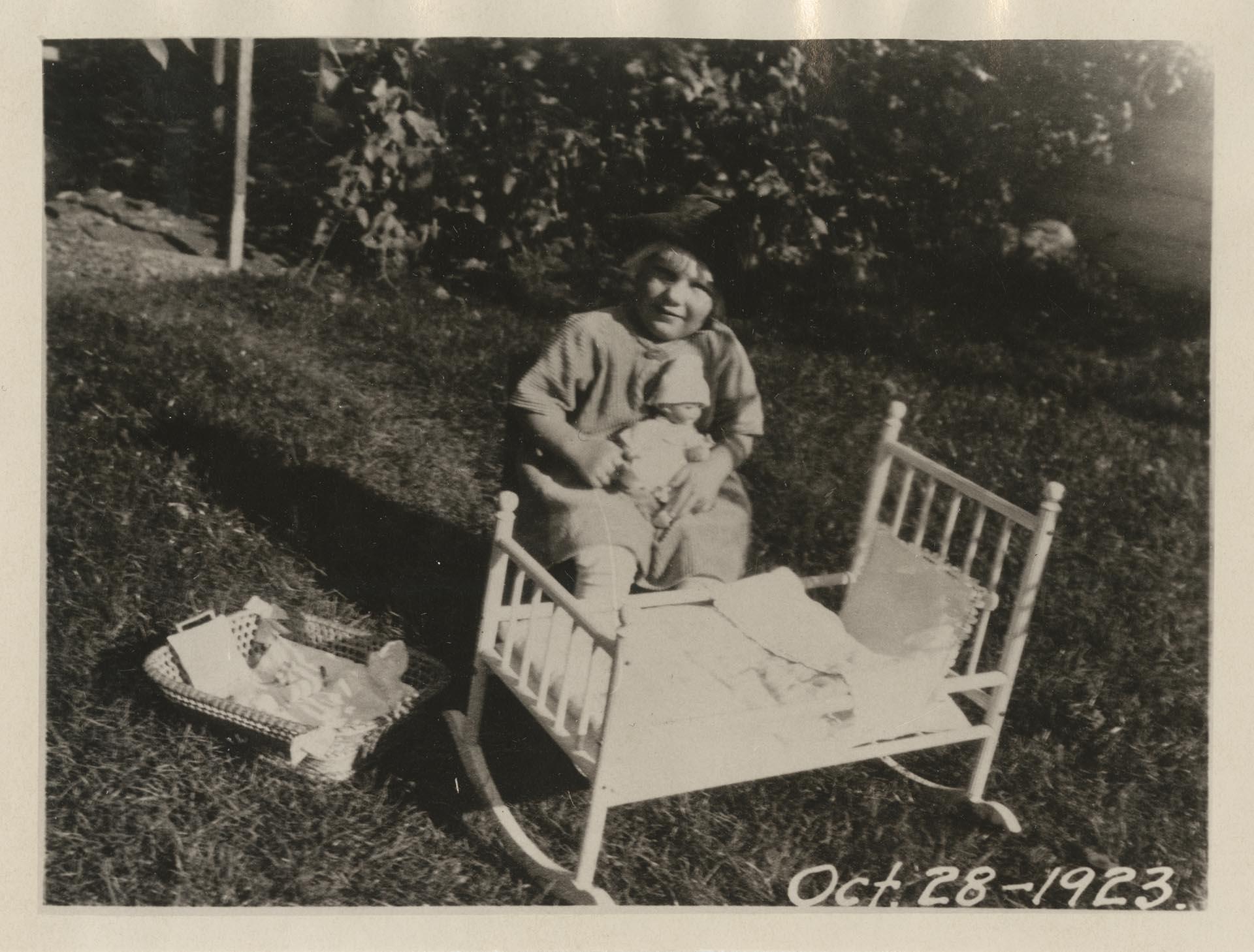 Image of Margaret Levald Jensen with doll and cradle, Seattle, October 28, 1923