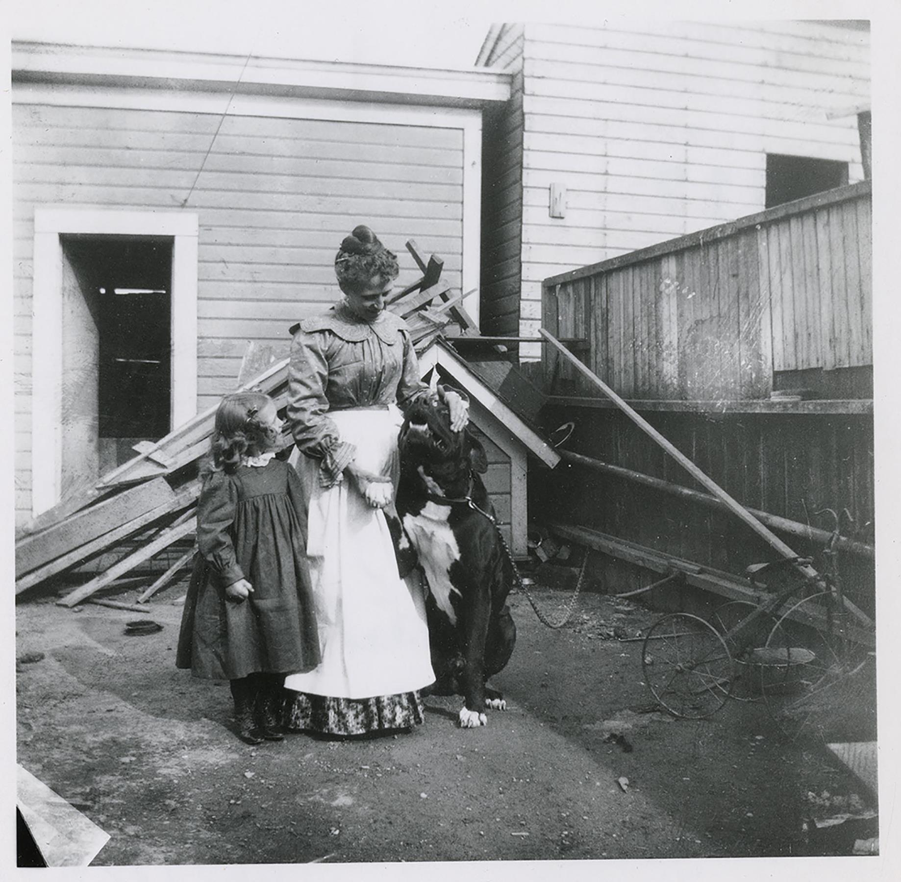 Image of Anna and Viola Brand with the family dog in backyard, Seattle, 1901