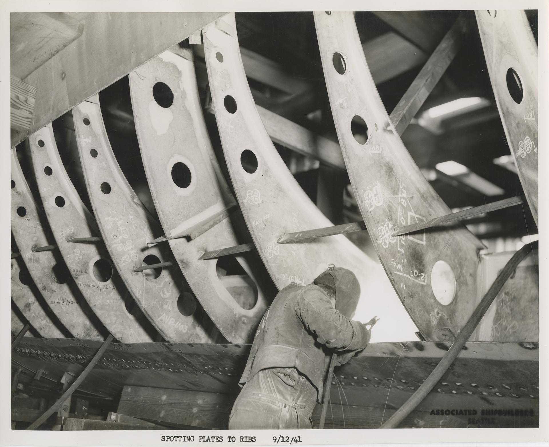 Image of Associated Shipbuilding employee spot welding plates to ribs, Seattle, September 12, 1941