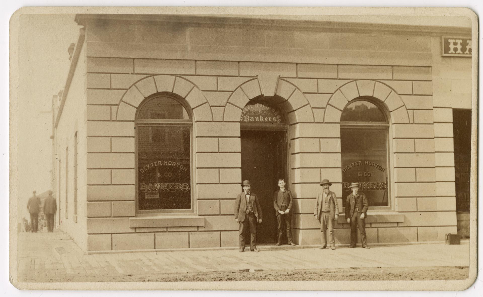 Image of Arthur and Rolland Denny standing in front of the Dexter Horton Bank, Seattle, circa 1880