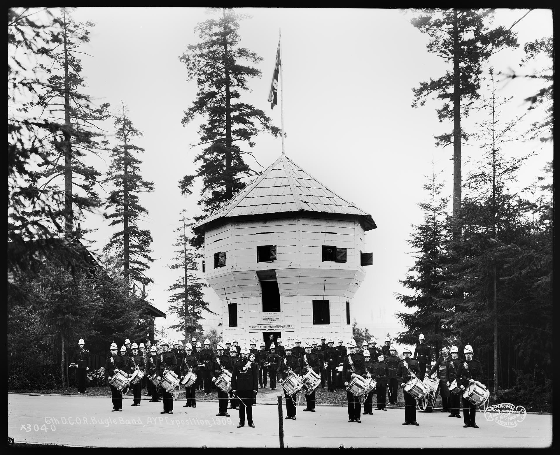 Image of Canadian military band in front of the Vancouver Daily World headquarters at the Alaska-Yukon-Pacific Exposition, 1909
