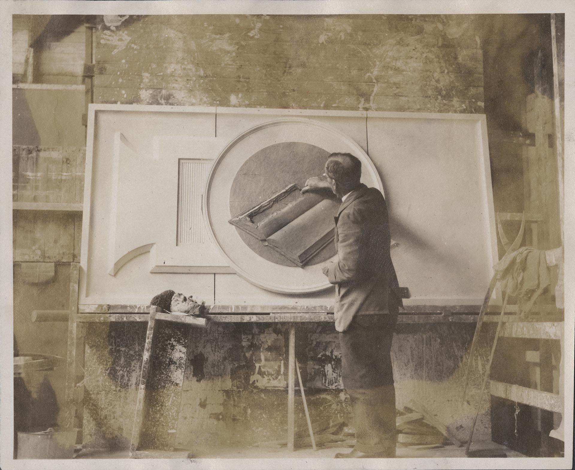 Image of Frank Lemon working on clay model at Pacific Stone Company, Seattle, circa 1926
