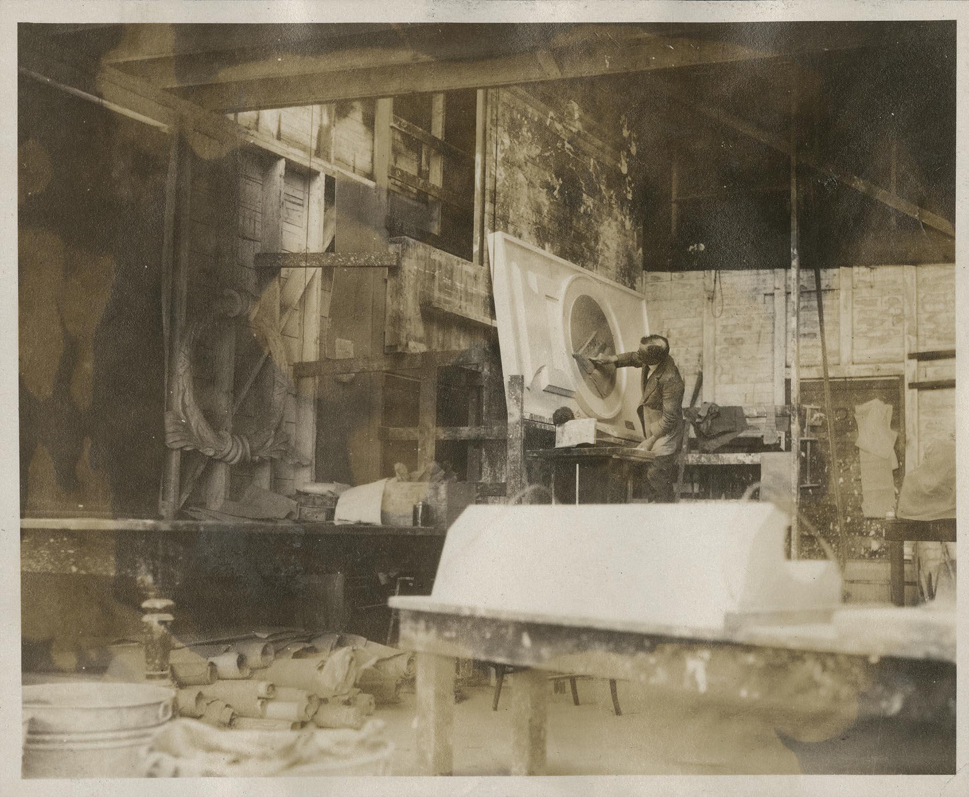 Image of Frank Lemon working on clay model at Pacific Stone Company, Seattle, circa. 1926