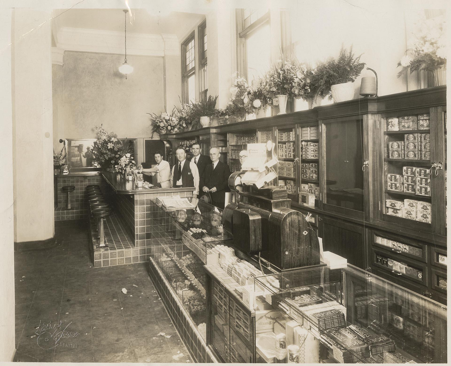 Image of Benjamin M. Paris and three men posing at Ben Paris Sporting Goods and Recreation, Seattle, circa 1930