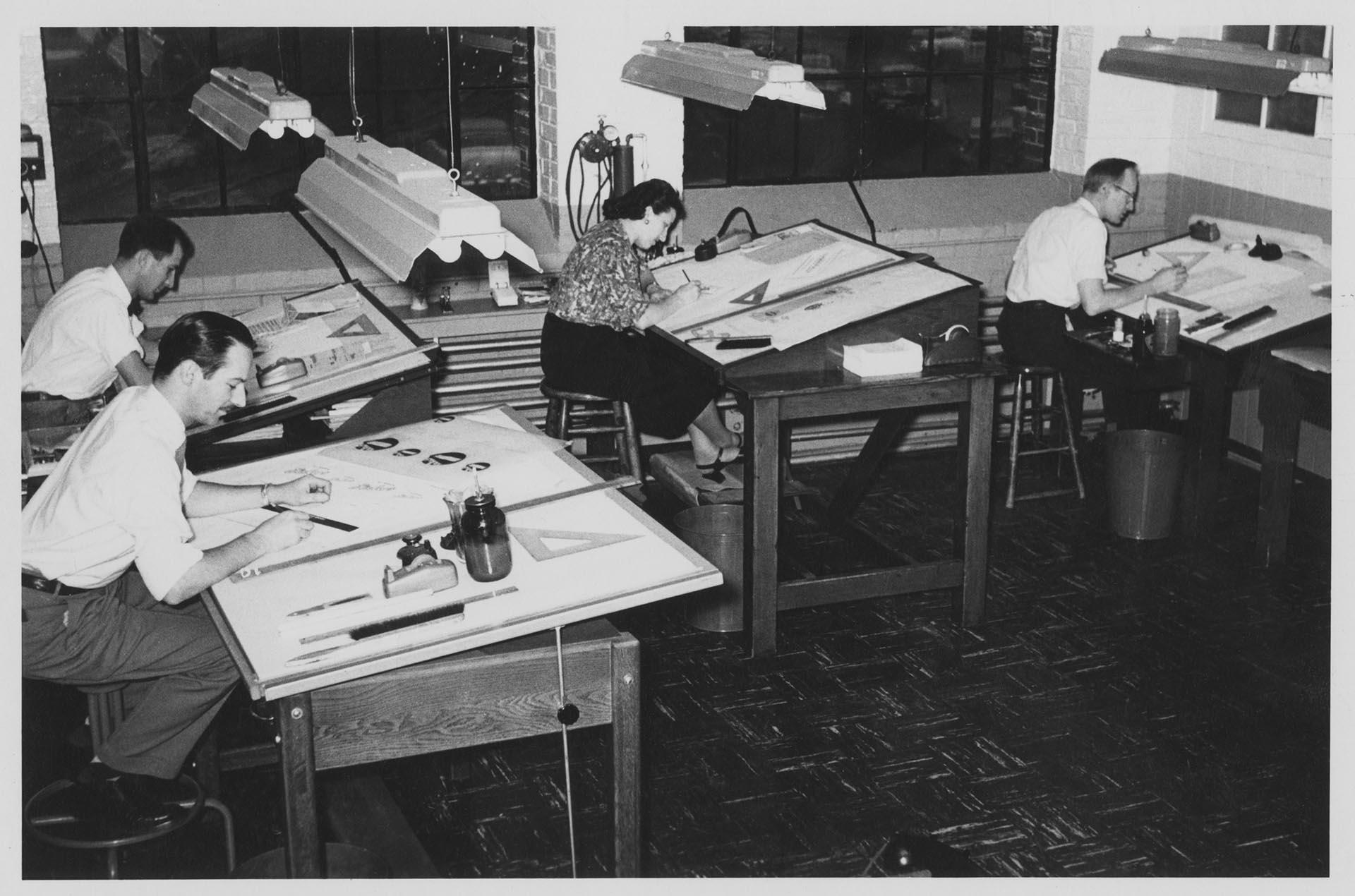 Image of Four members of Bemis Bag Co. art department working at drafting tables, circa 1955