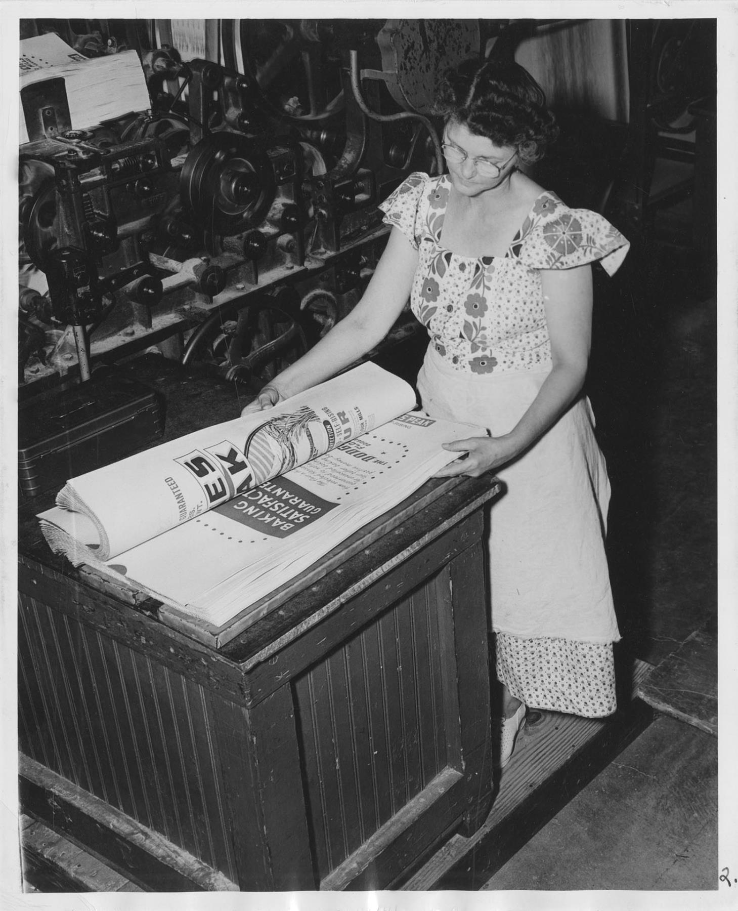 Image of Woman at Bemis Bag Co. preparing finished bags for packing, circa 1950