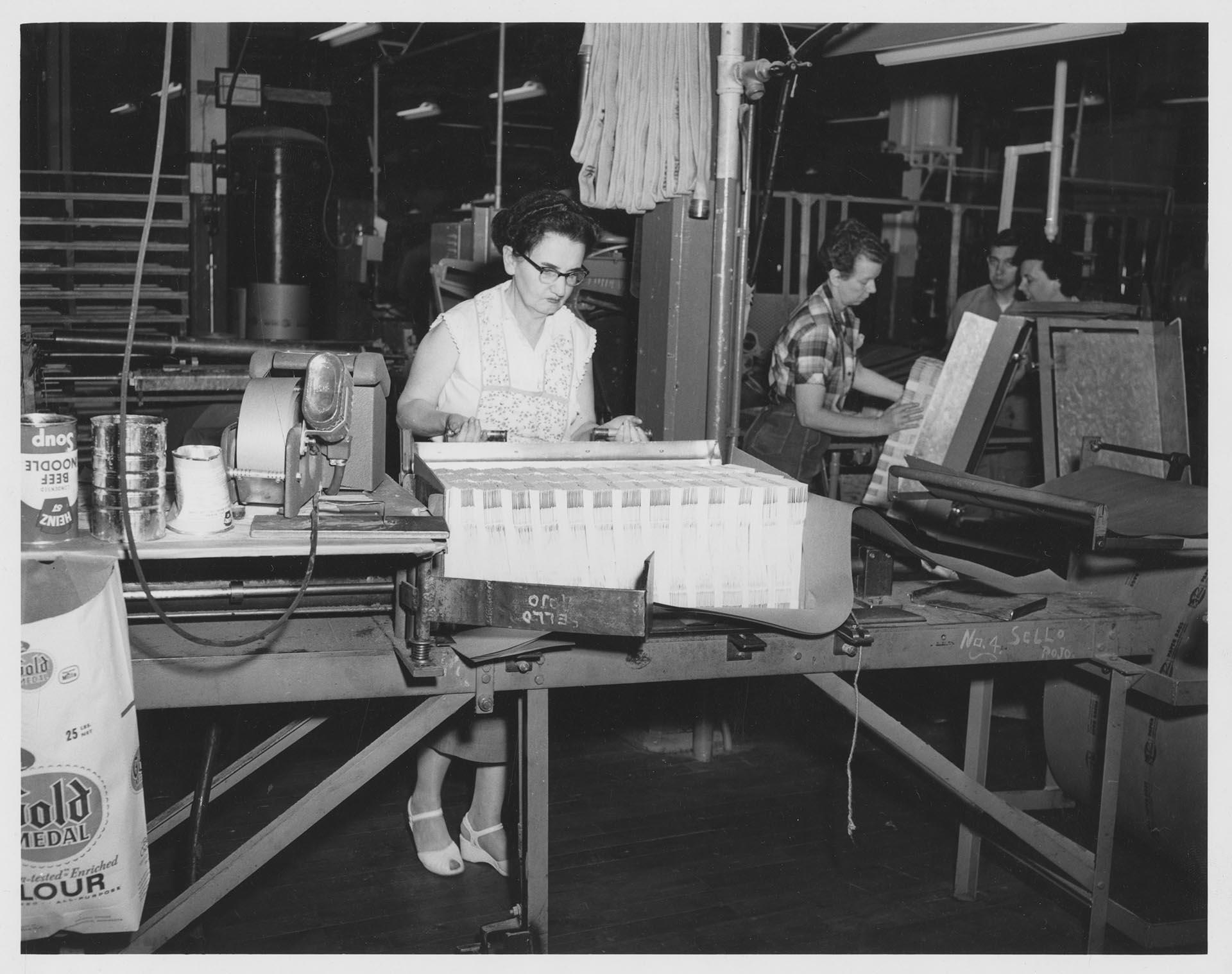 Image of Woman at Bemis Bag Co. plant with packaged paper bags, circa 1950