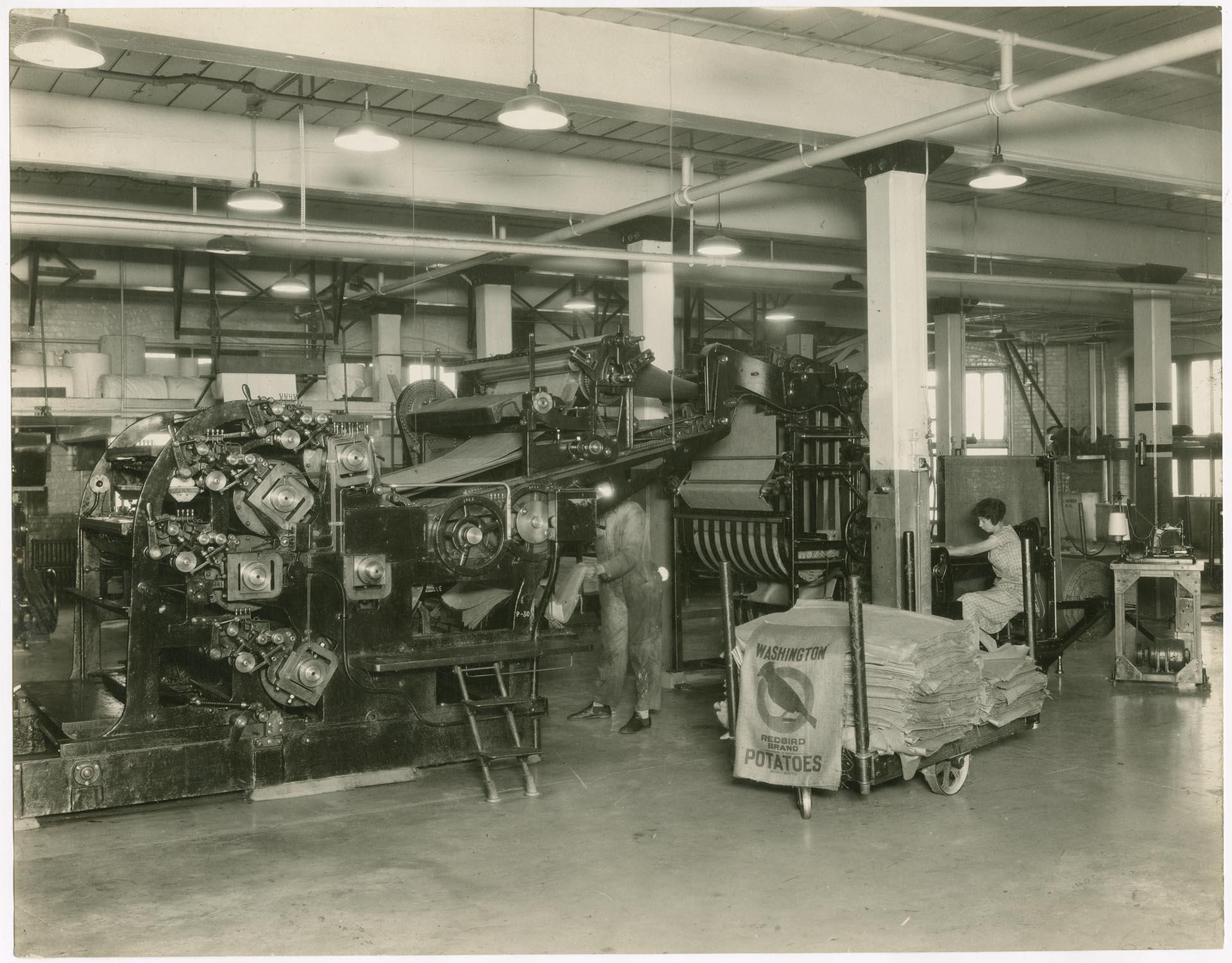 Image of Bemis Bag Co. employees working at burlap web press, November 30, 1926