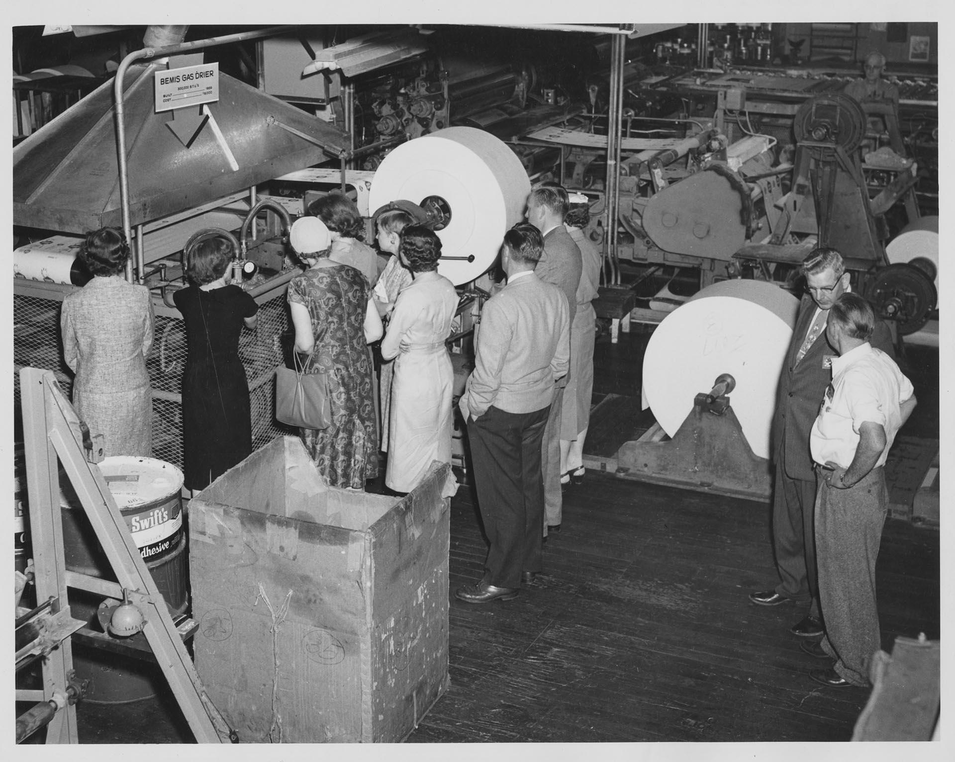 Image of Group of teachers looking at gas dryer during Bemis Bag Co. factory tour, Seattle, 1959