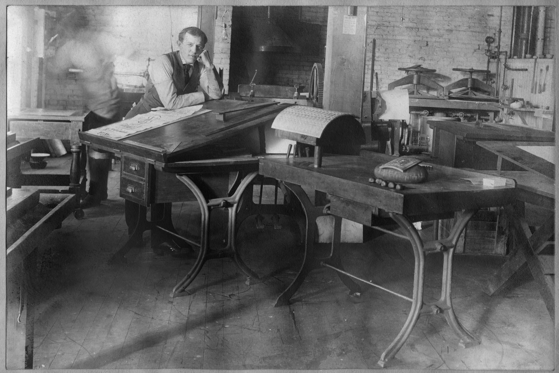 Image of Man leaning on drafting table in Bemis Bag Co. art department, Seattle, circa 1925