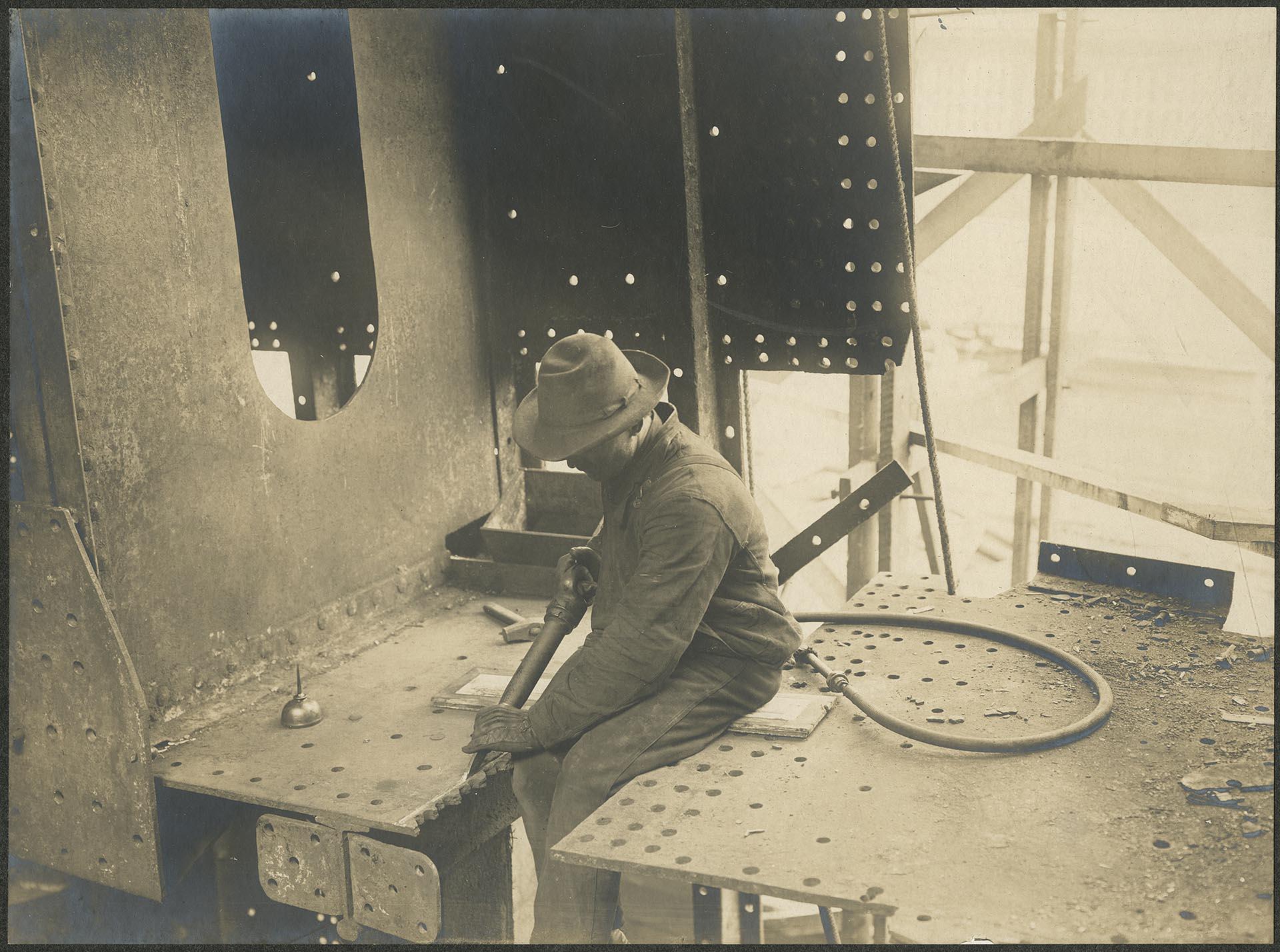 Image of Moran Brothers employee operating a compressed air chipping gun, Seattle, circa 1902