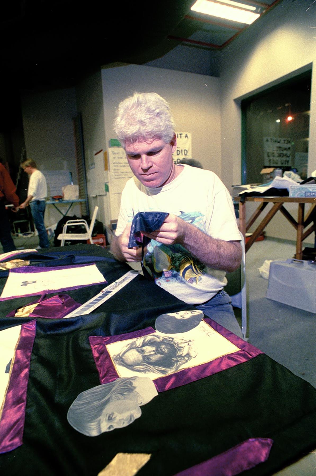 Image of Wayne Blakely working on an AIDS quilt, November 29, 1991
