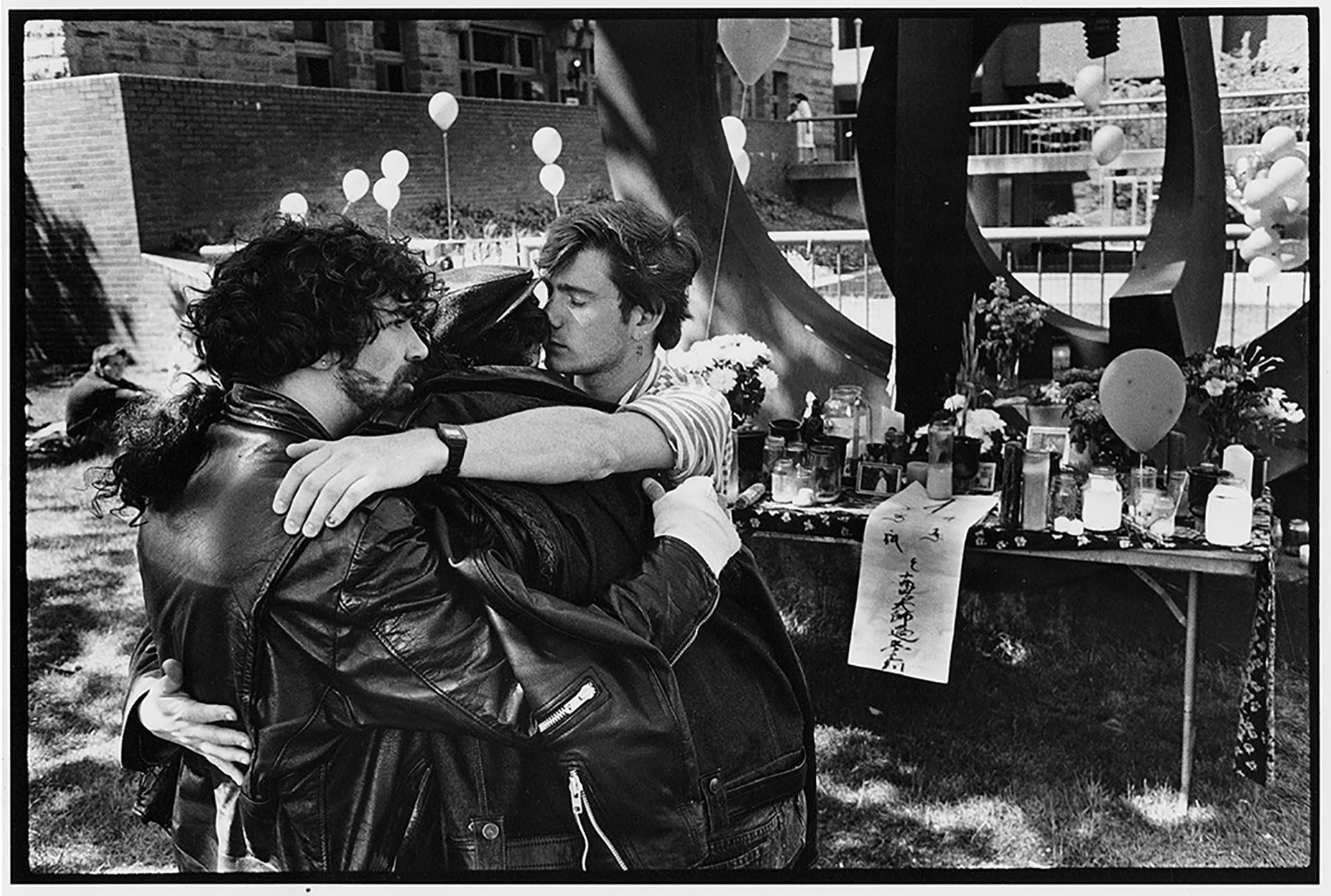 Image of Men embracing at AIDS vigil at Seattle Central Community College, May 29, 1988