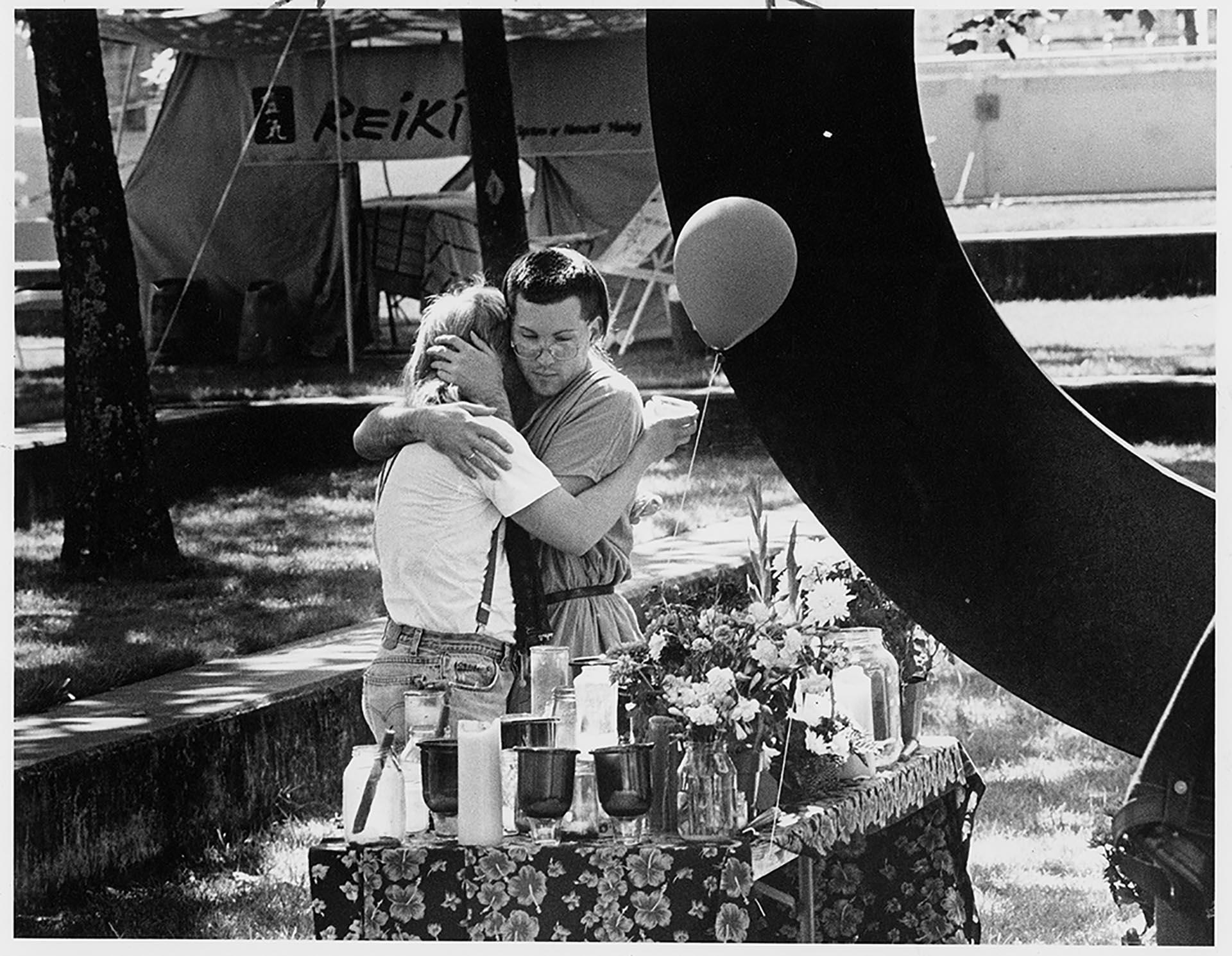 Image of Two men embracing at AIDS vigil at Seattle Central Community College, May 29, 1988