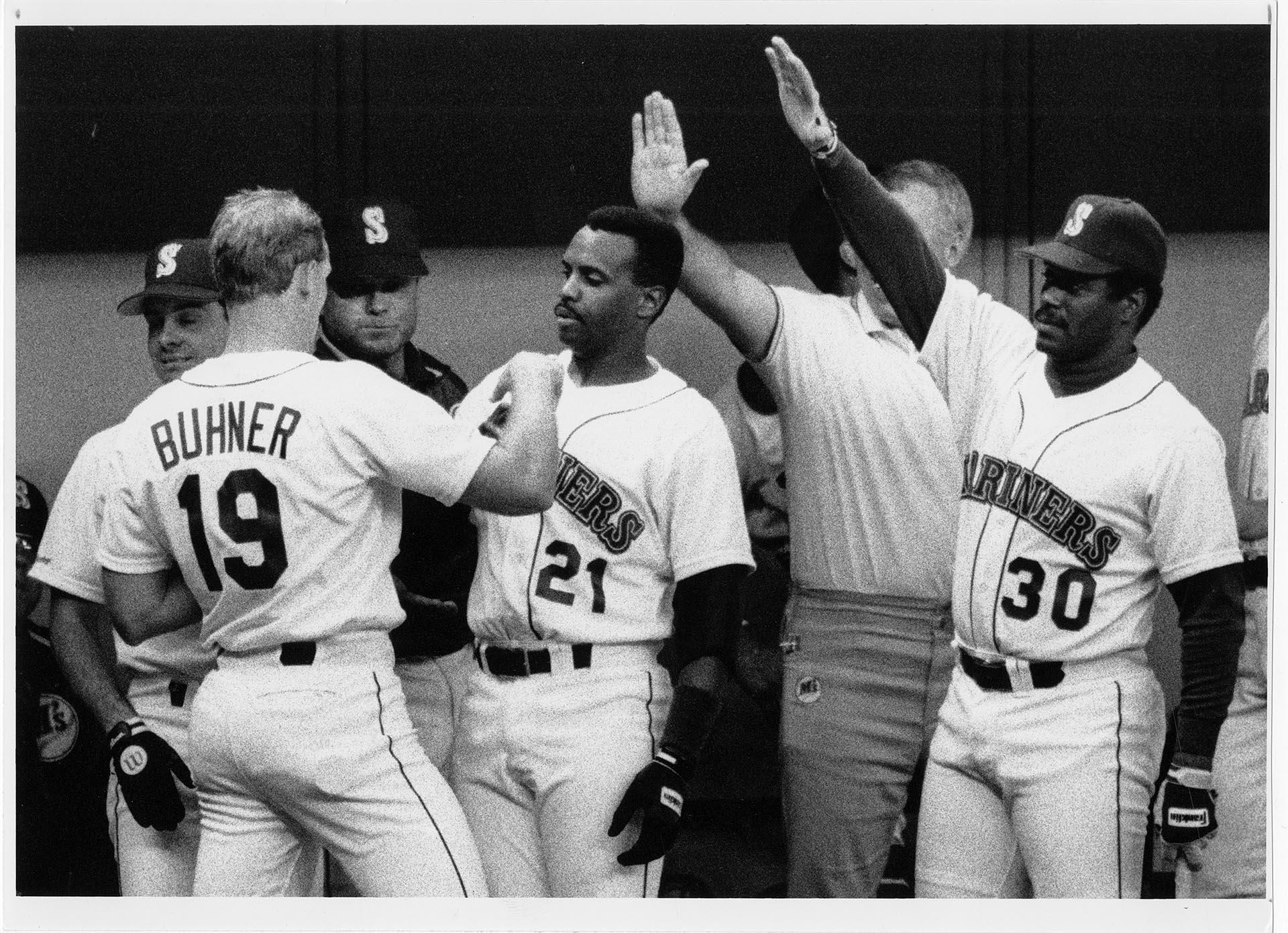 Image of Mariners players high-fiving after winning game against Texas Rangers, May 24, 1991