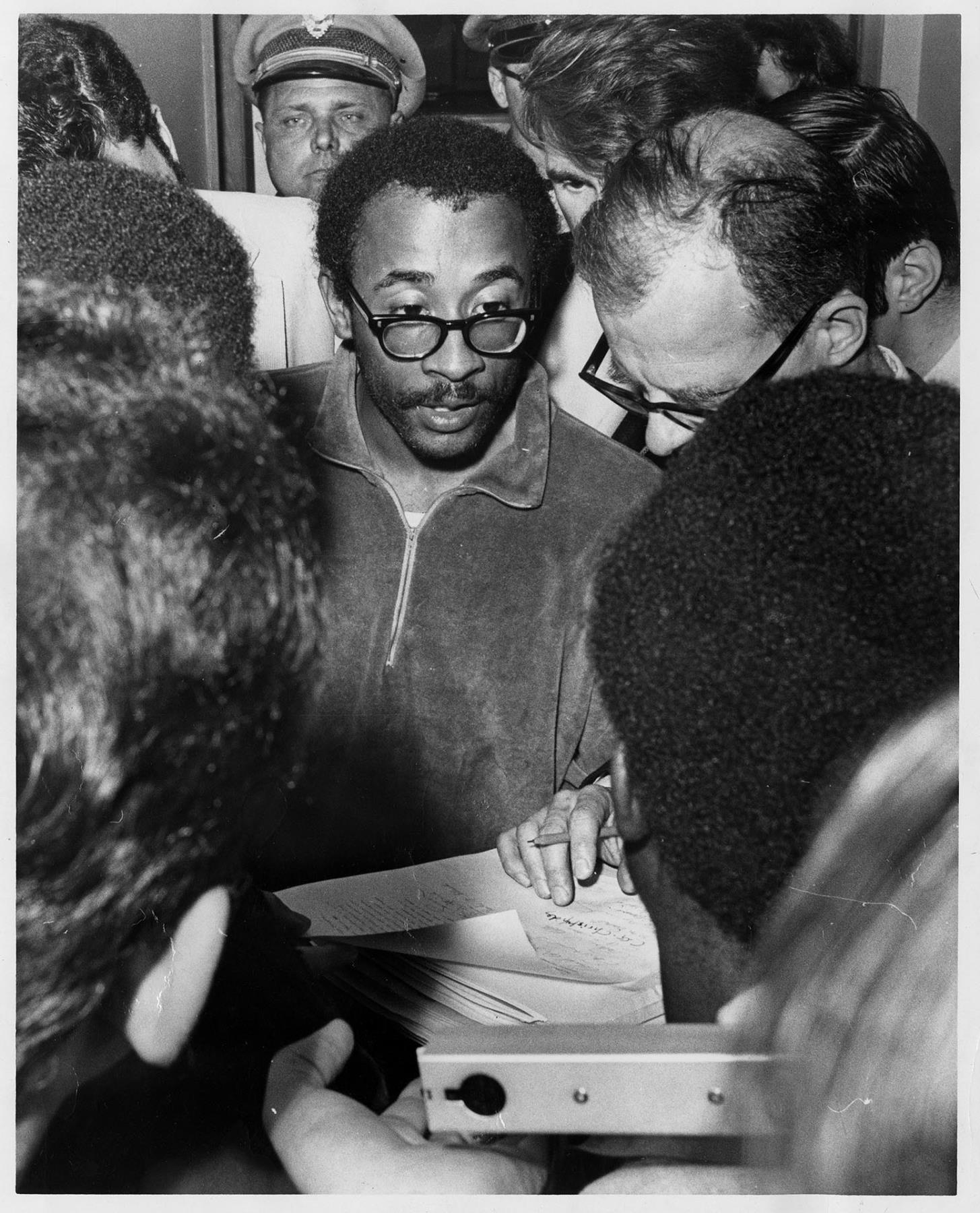 Image of UW BSU president E.J. Brisker signing University agreement after protest, May 23, 1968