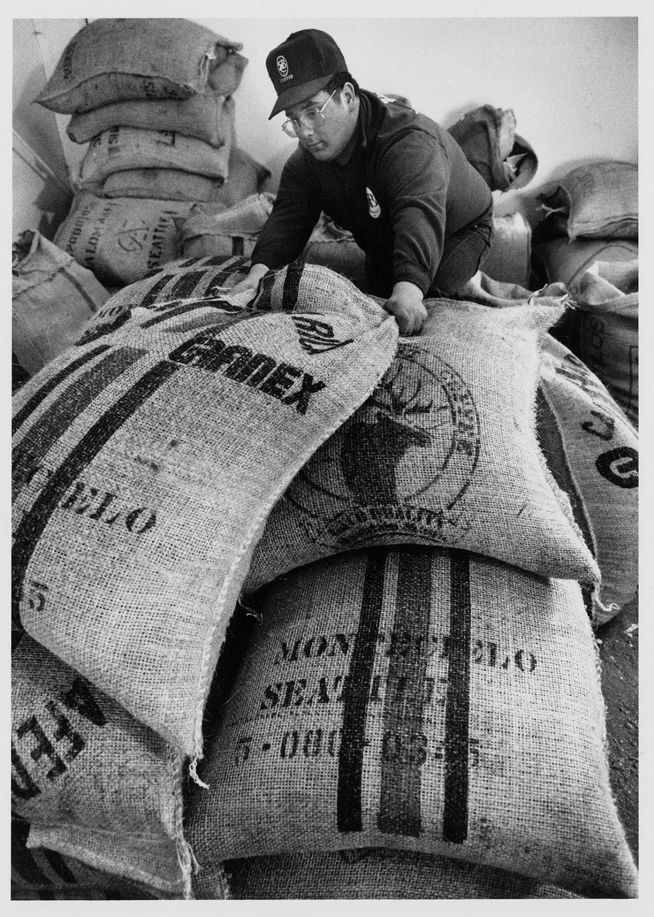 Image of Matthew Radford moving Seattle's Best Coffee bags at warehouse, Vashon Island, March 22, 1991