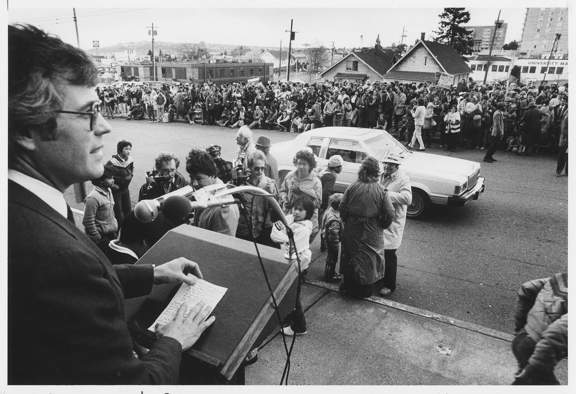 Image of Donovan Cook speaking before a march honoring archbishop of El Salvador, Seattle, March 27, 1983