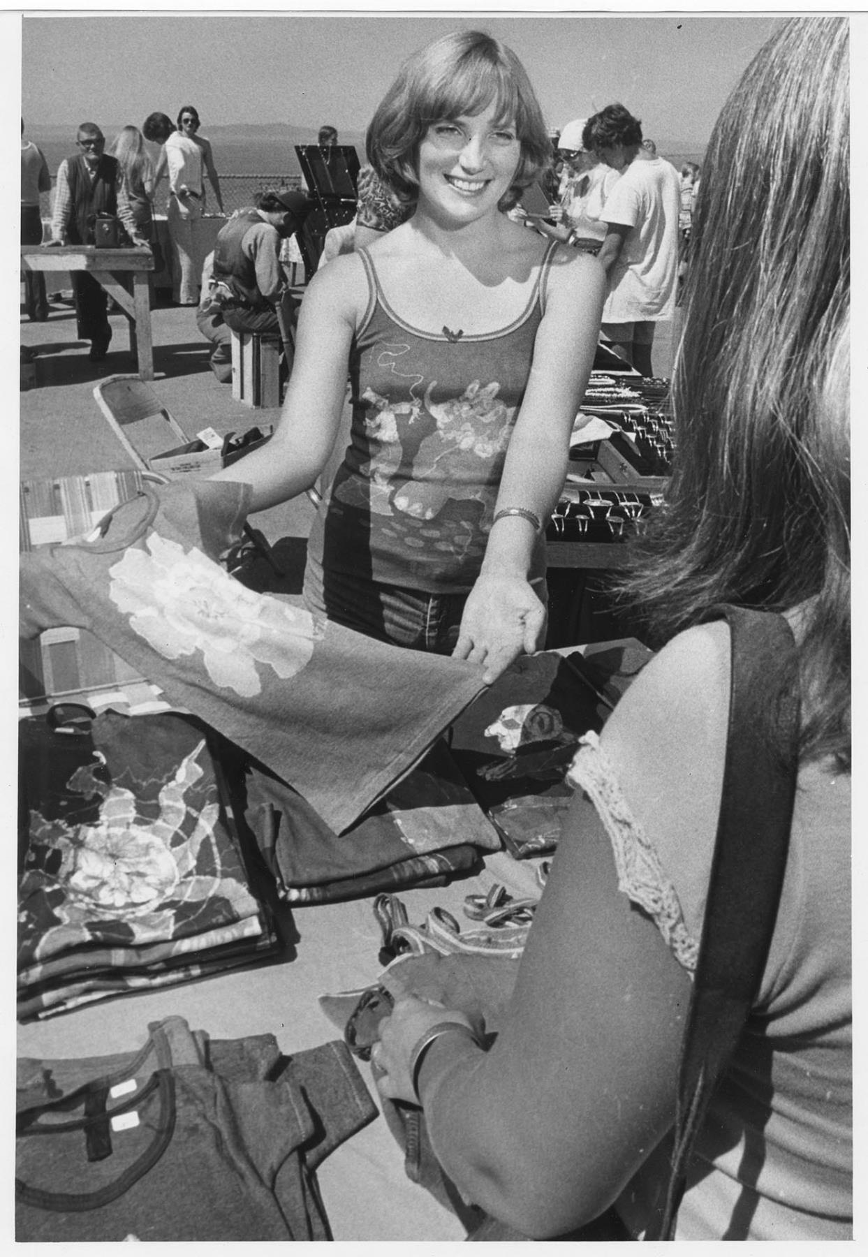 Image of Vendor selling painted t-shirts at Pike Place Market, July 16, 1976