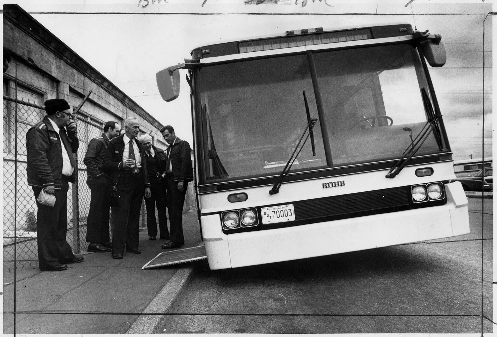 Image of Metro drivers inspecting prototype kneeling bus, Seattle, March, 1975