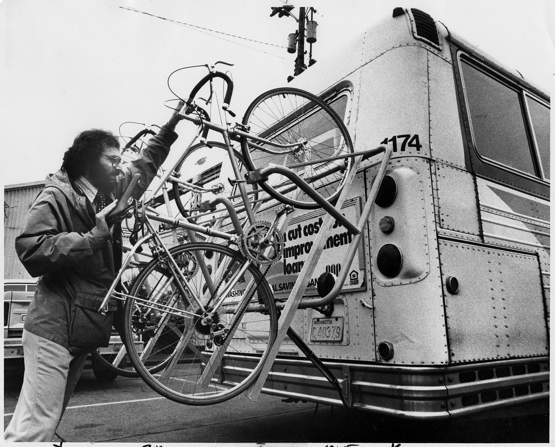 Image of Tom Friedman demonstrating experimental bike rack, Seattle, April 27, 1978
