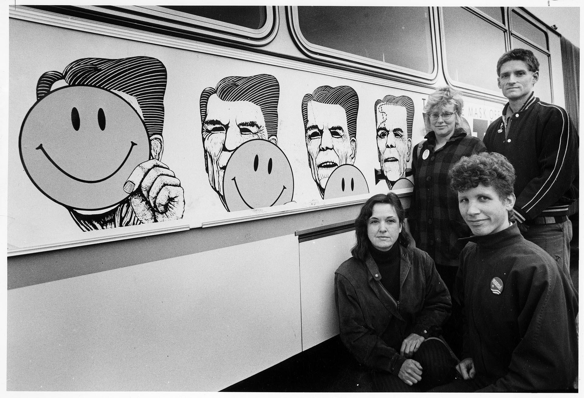 Image of Artists posing with their political ad campaign on Metro bus, Seattle, October 23, 1984