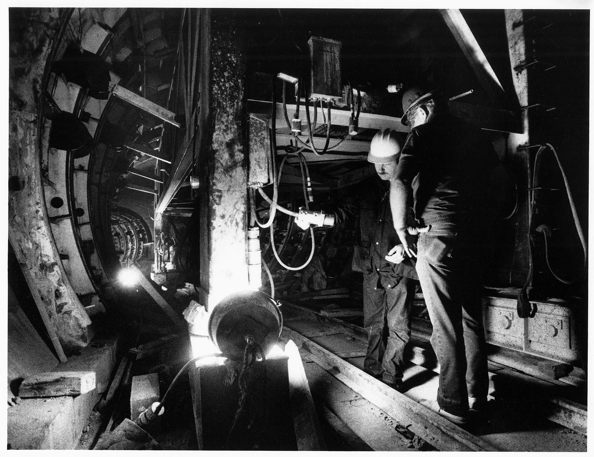 Image of Jim Lukehart investigating an electrical connection in bus tunnel, Seattle, December 12, 1988