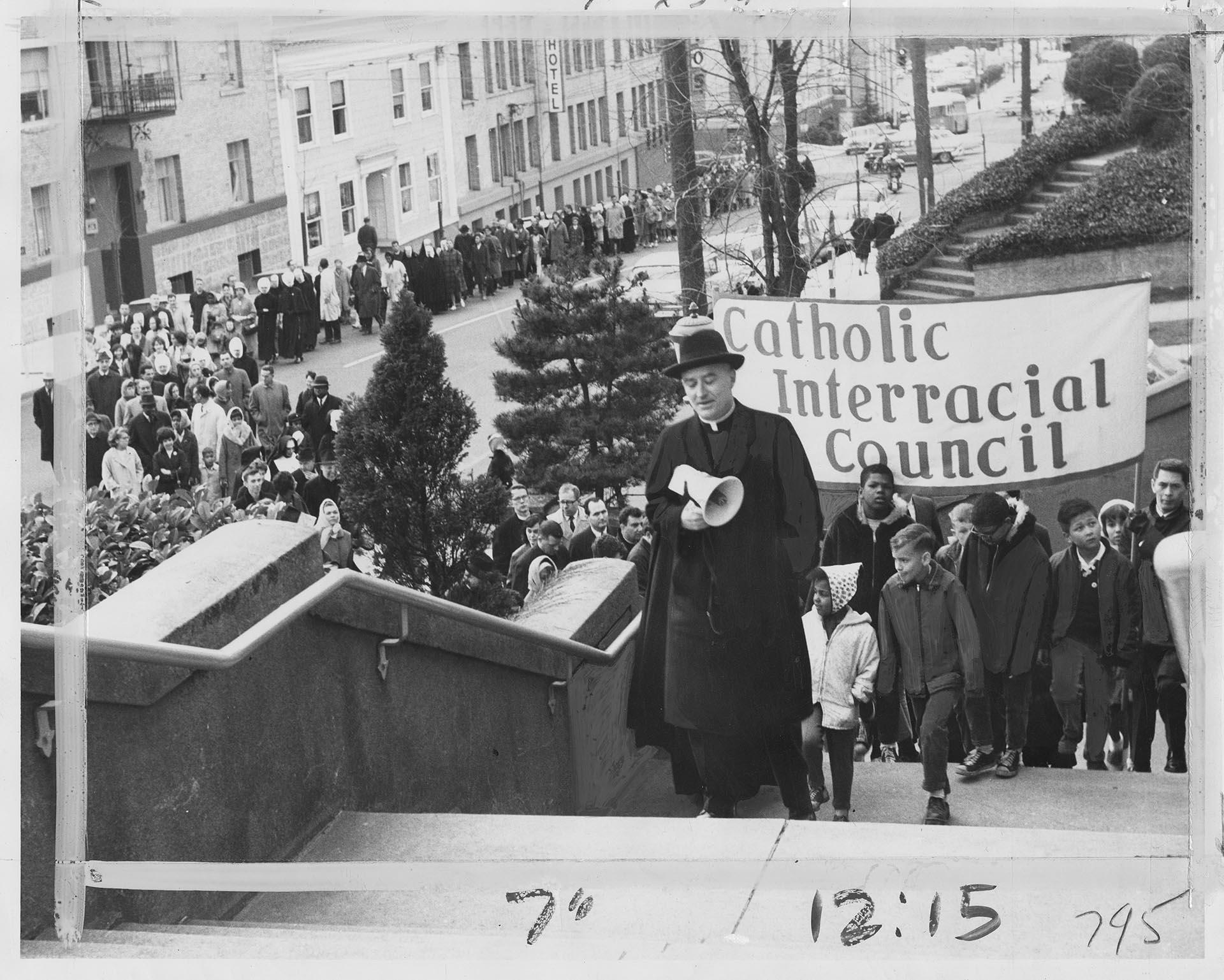 Image of Father John Lynch leading marchers to St. James Cathedral, Seattle, March 16, 1965