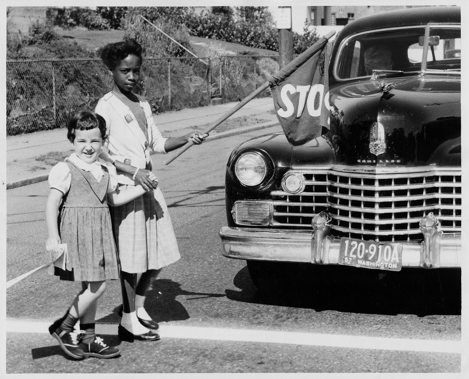 Image of Two girls crossing street near Madrona School, Seattle, September 1957