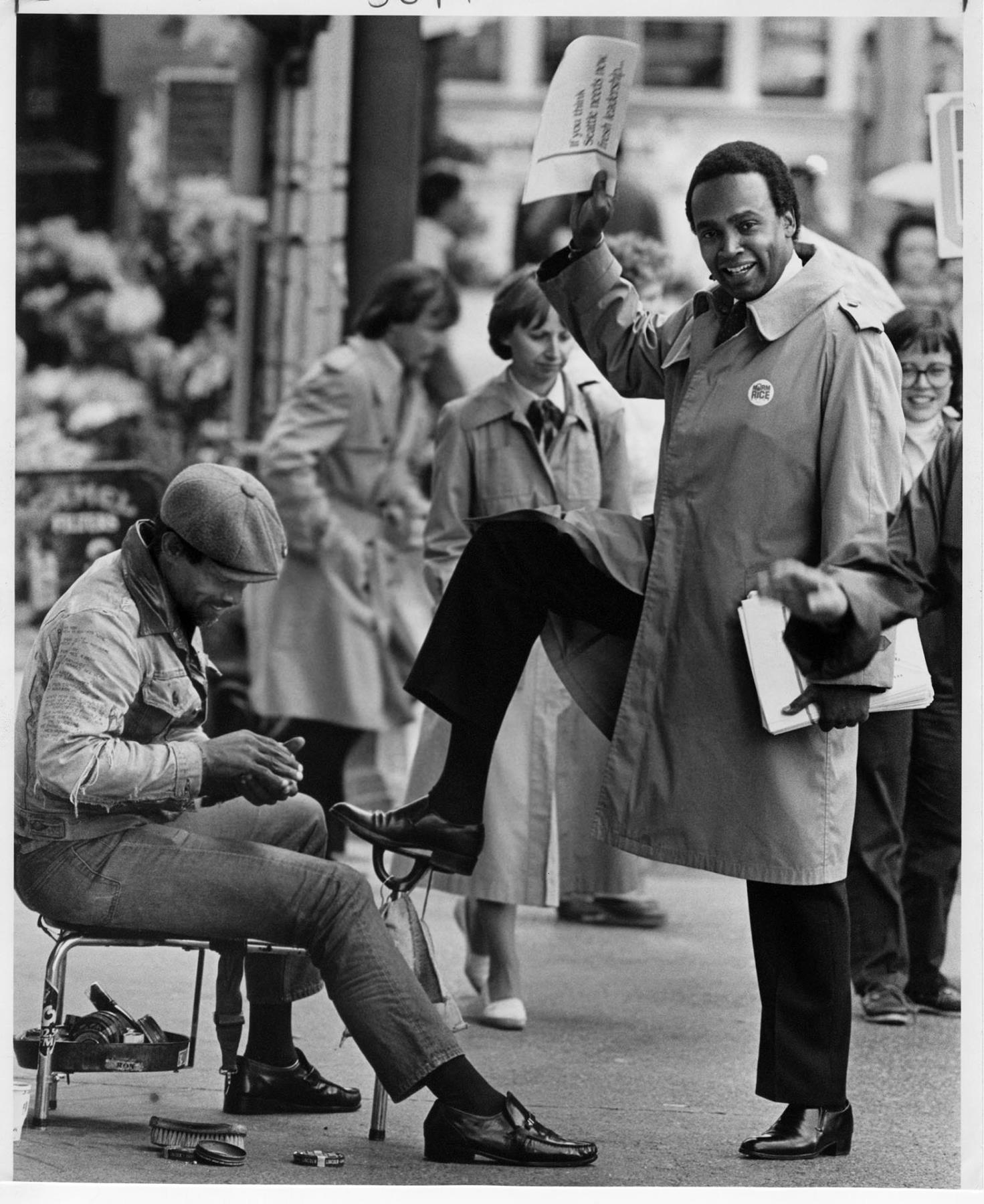 Image of Norm Rice getting a shoeshine near Westlake Mall, Seattle, September 17, 1985
