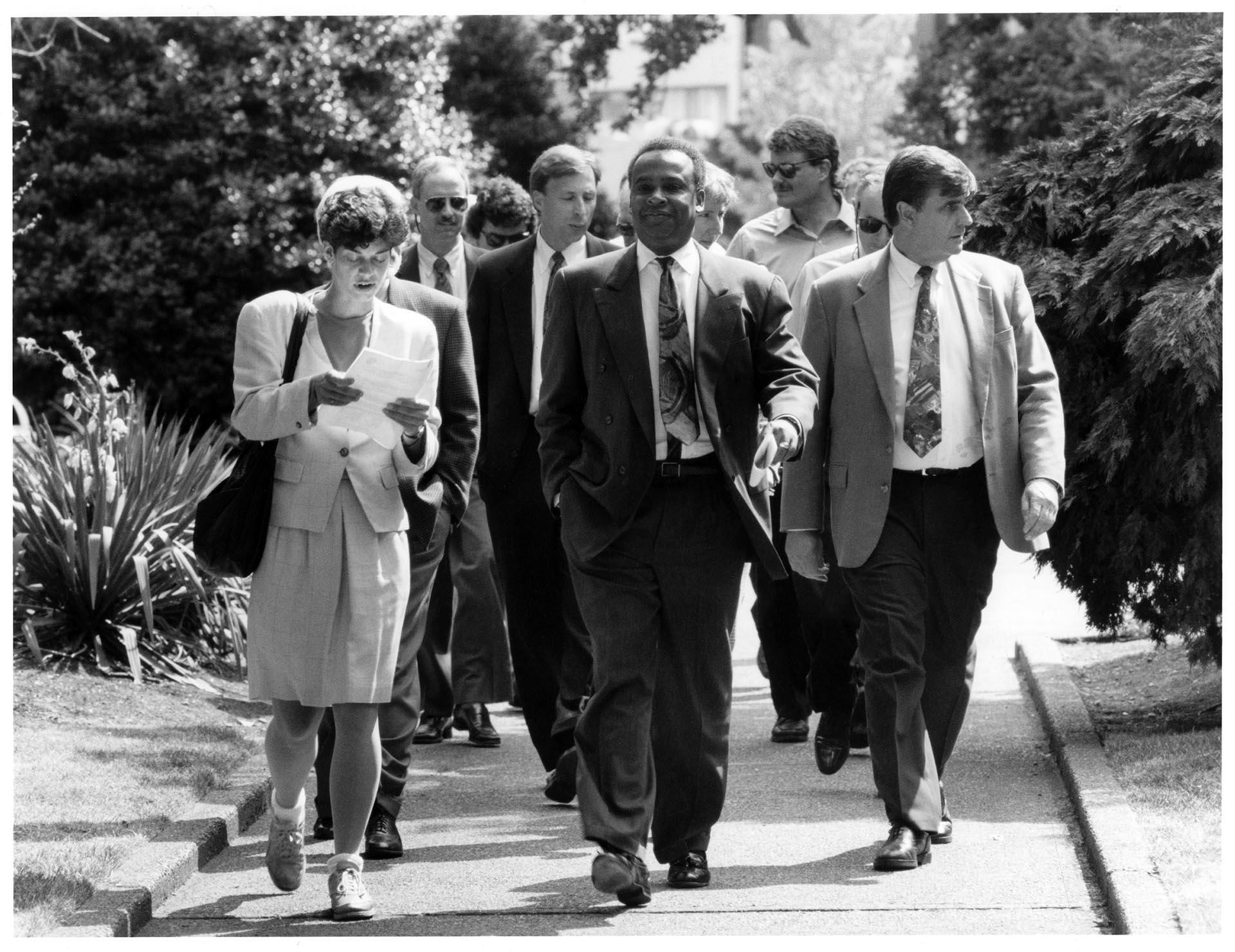 Image of Norm Rice and others touring the proposed Seattle Commons site, August 10, 1993