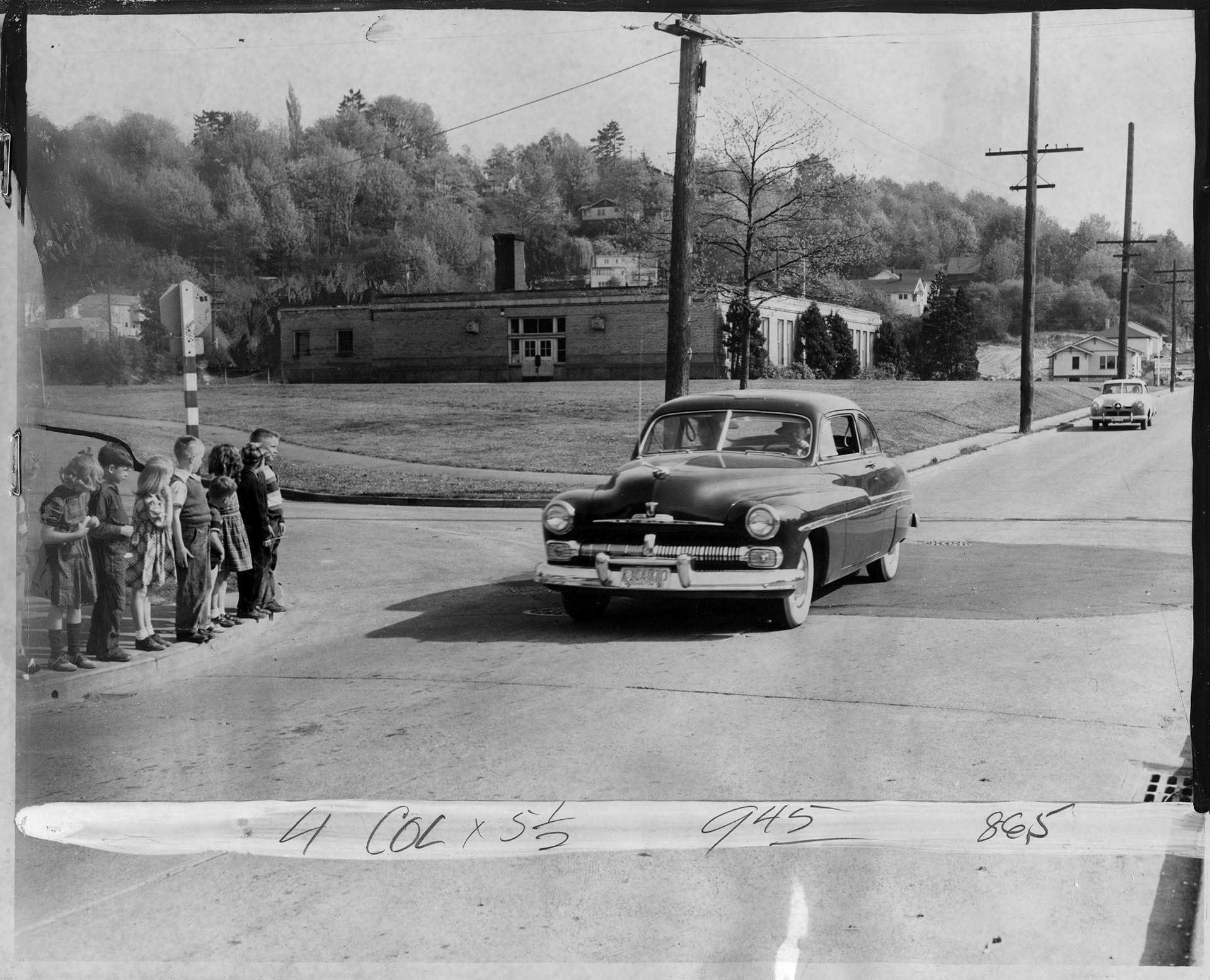 Image of Children crossing 32nd Ave. N. near Harrison School, Seattle, April 26, 1951