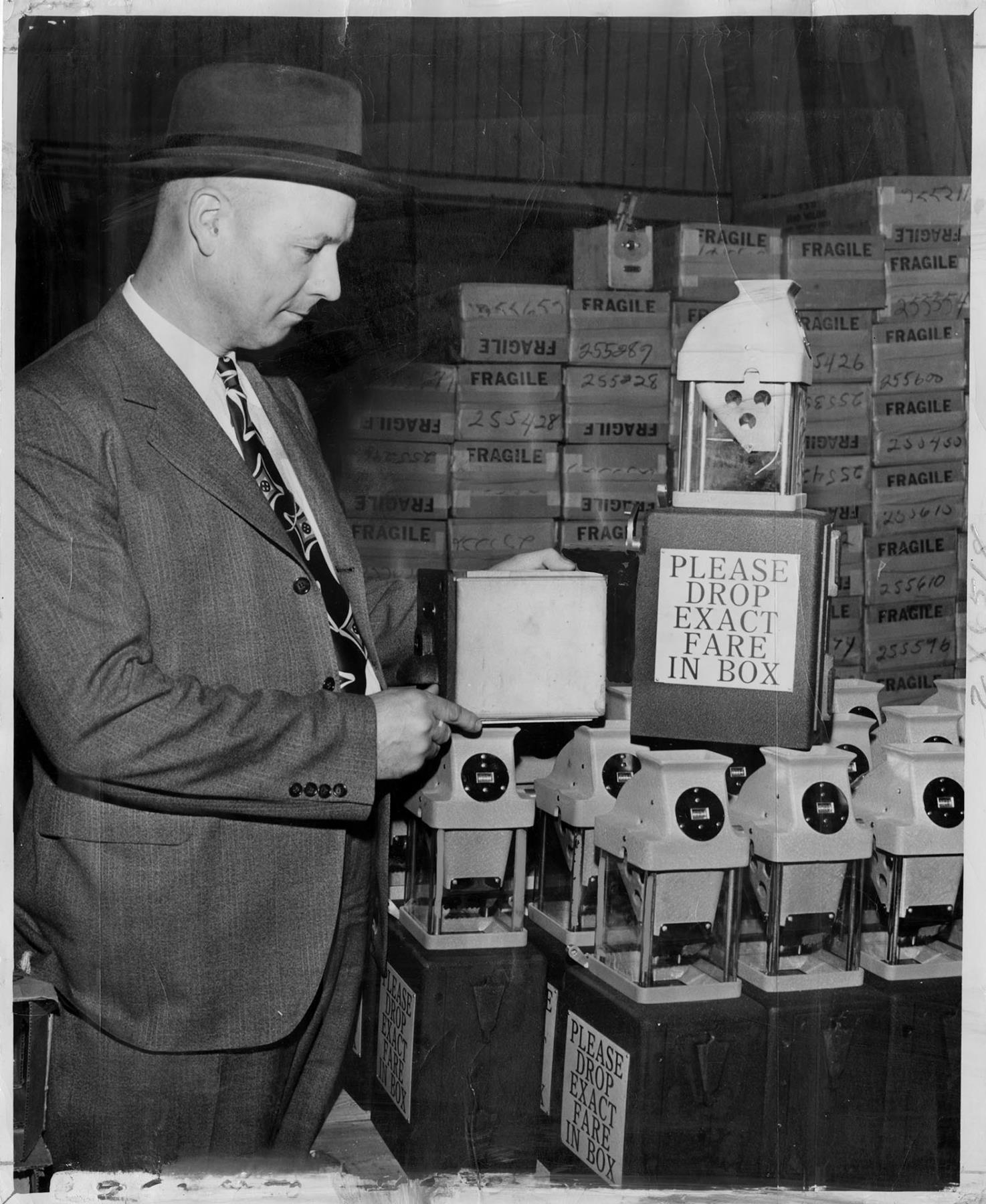 Image of George Moyer studying new transit fare boxes, Seattle, April 28, 1949