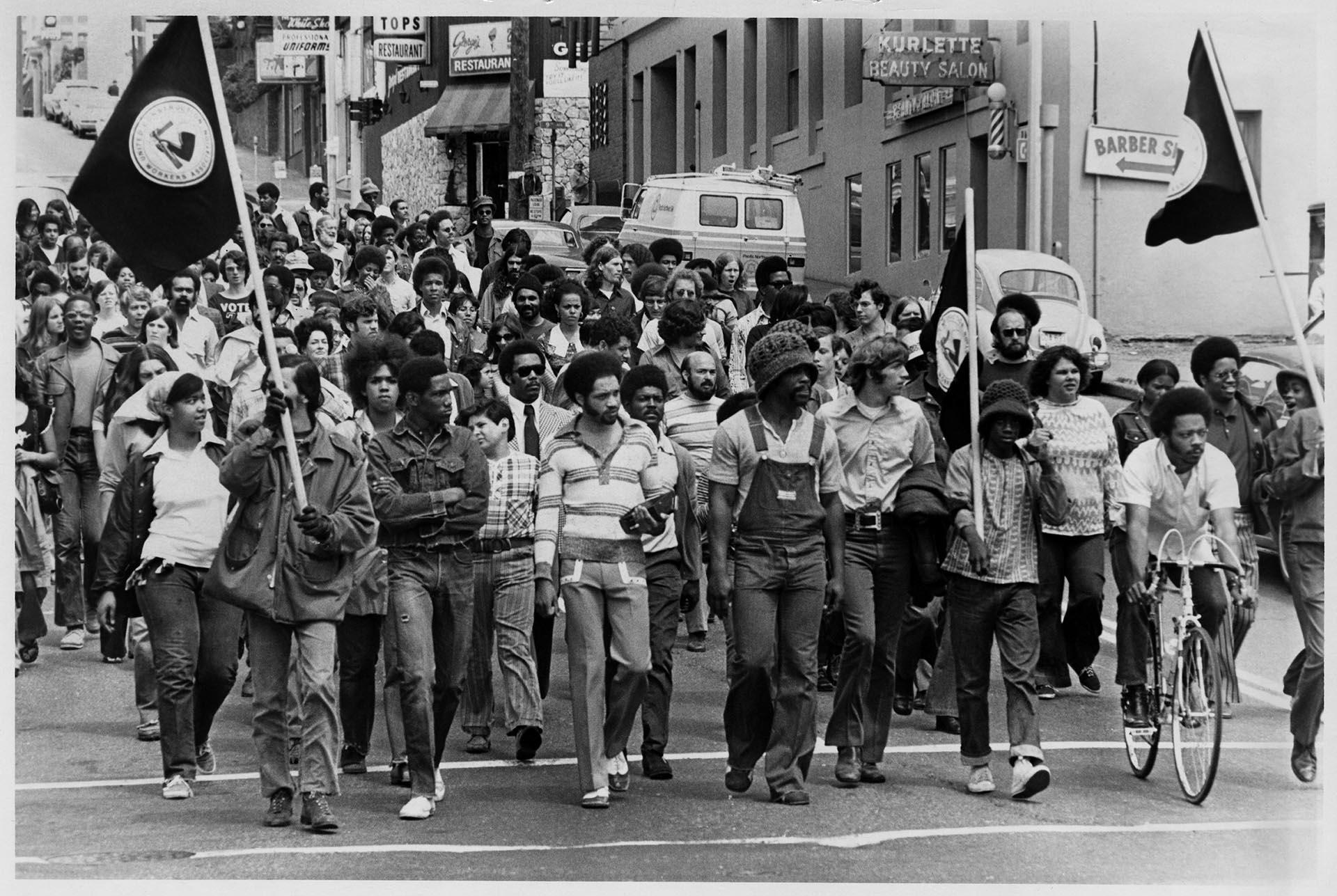 Image of UCWA members marching down Madison St., Seattle, July 7, 1972