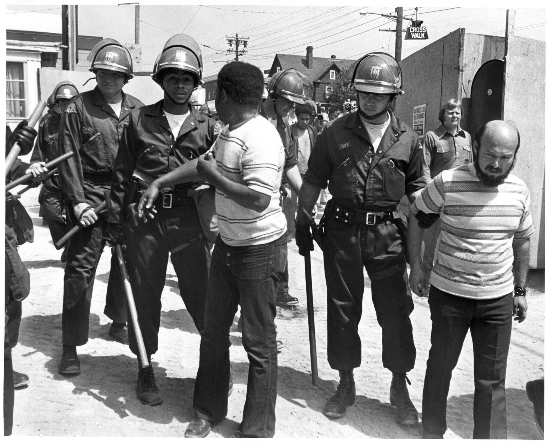 Image of Tyree Scott and Sam Martinez being arrested during UWCA protest, Seattle, June 8 1972