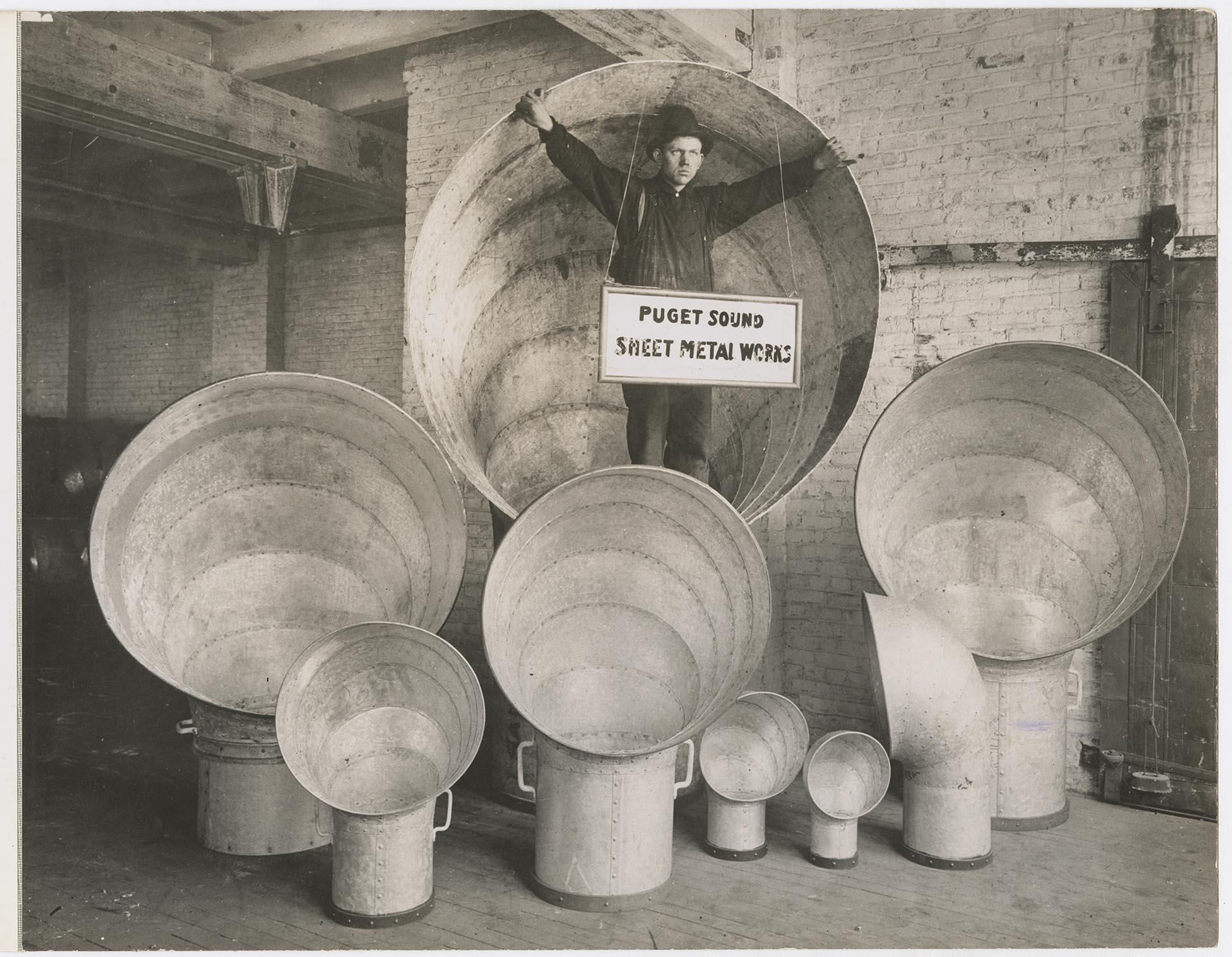 Image of Employee with ship ventilators at Puget Sound Sheet Metal Works, Seattle, circa 1918