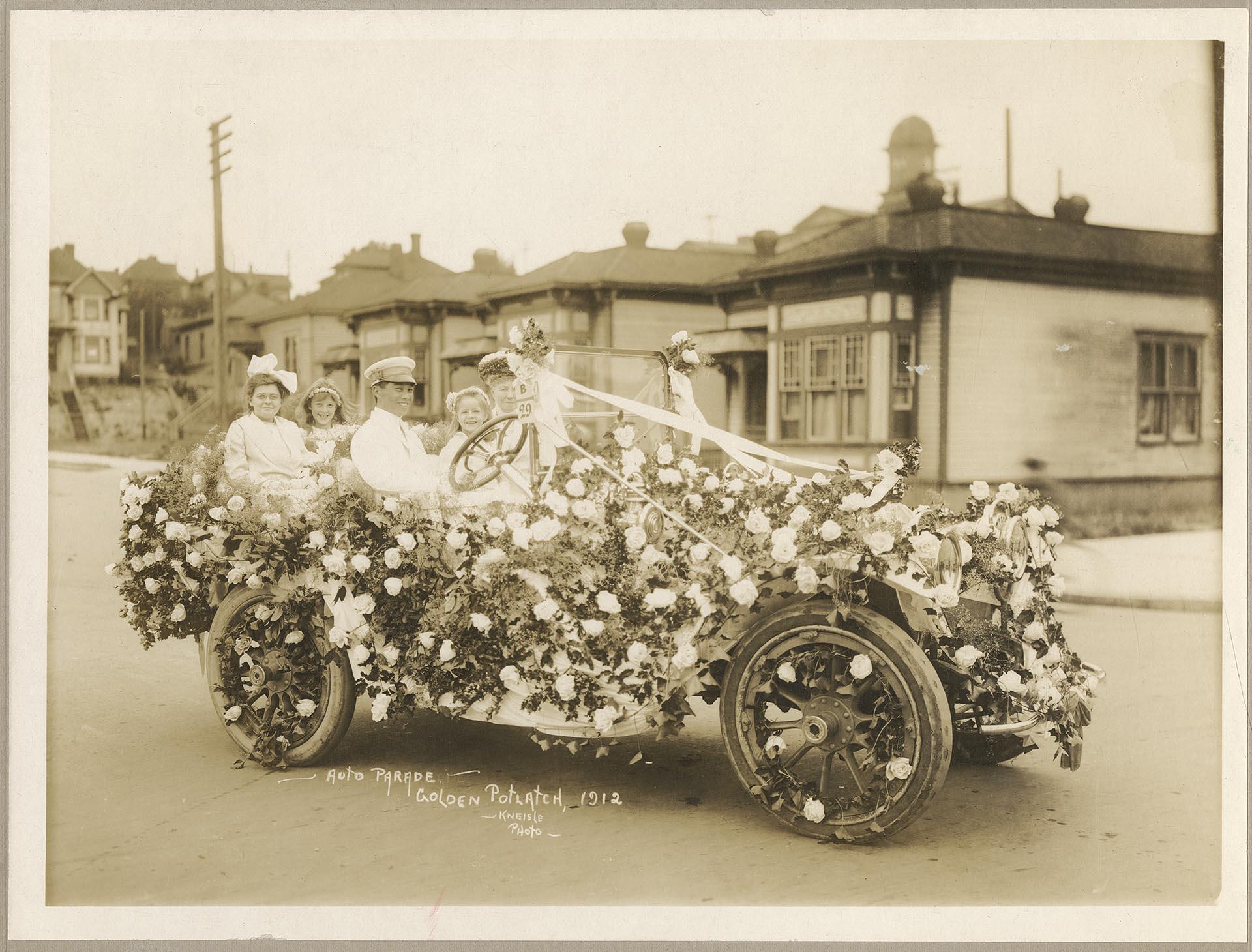 Image of Treat family in car decorated for Golden Potlatch parade, Seattle, 1912