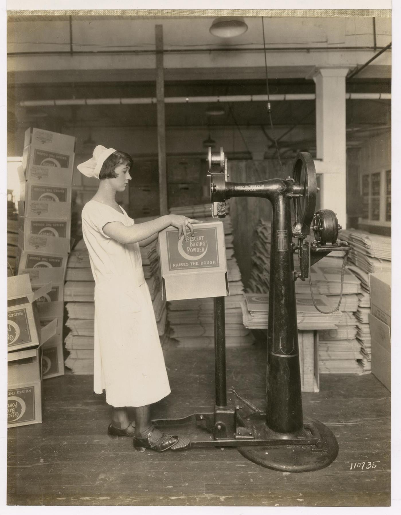 Image of Employee operating carton stapling machine at Crescent Manufacturing Company, Seattle, circa 1923