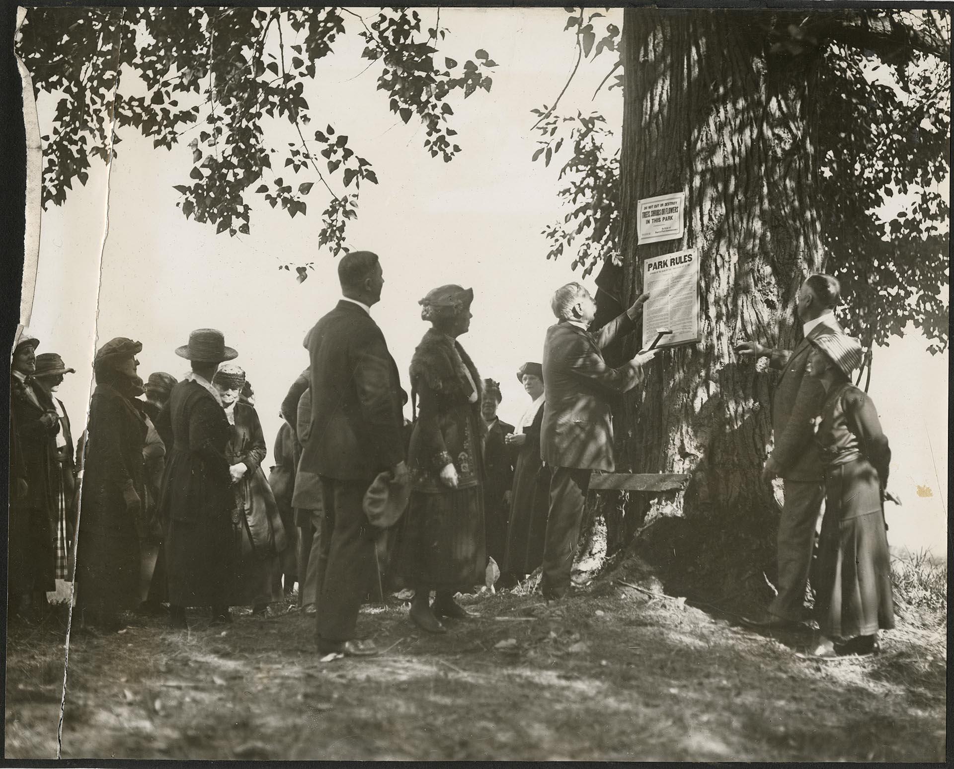 Image of Morgan J. Carkeek  posting park rules, Carkeek Park, Seattle, circa 1918