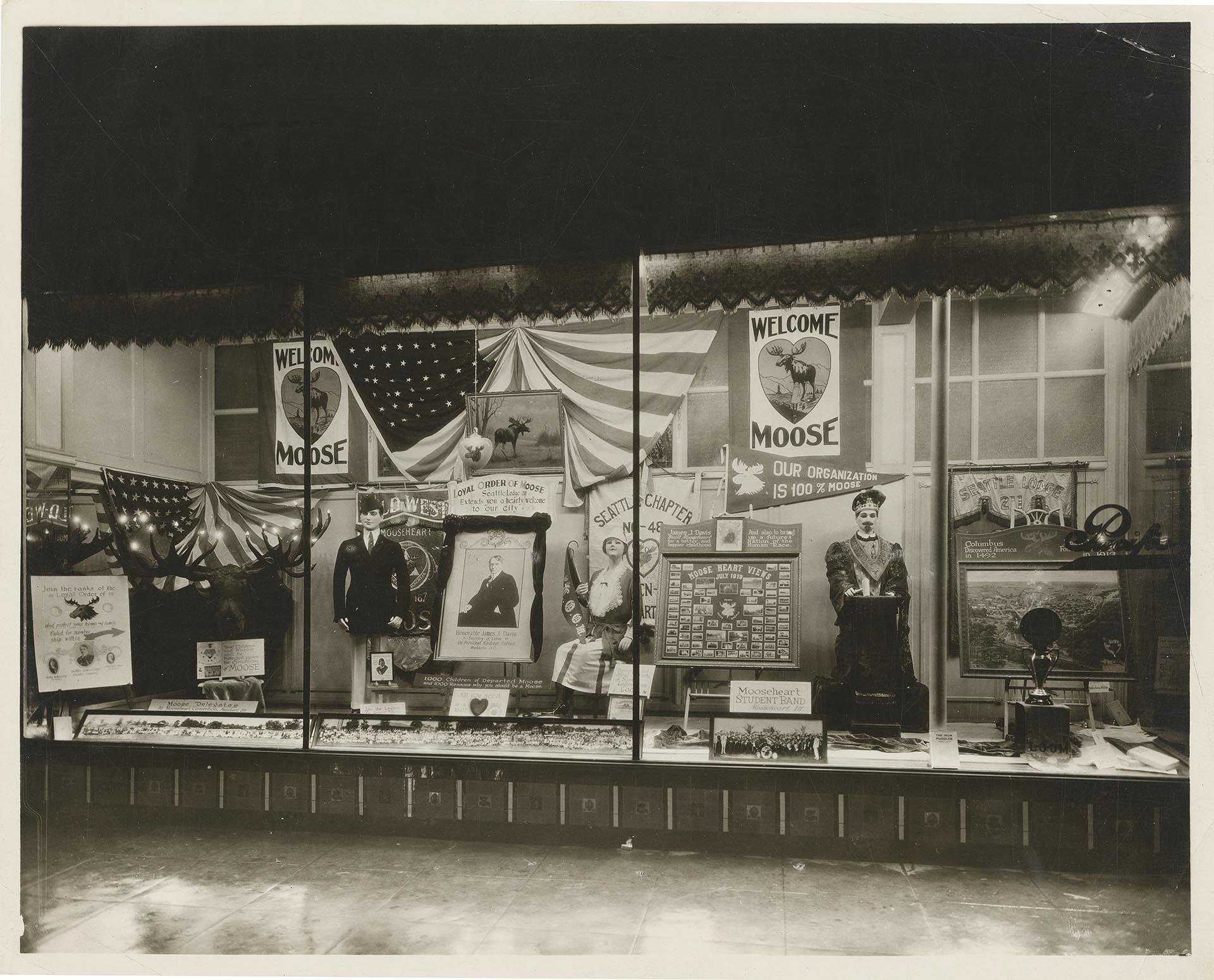 Image of Pacific Outfitting Company storefront display welcoming Loyal Order of Moose, Seattle, circa 1920
