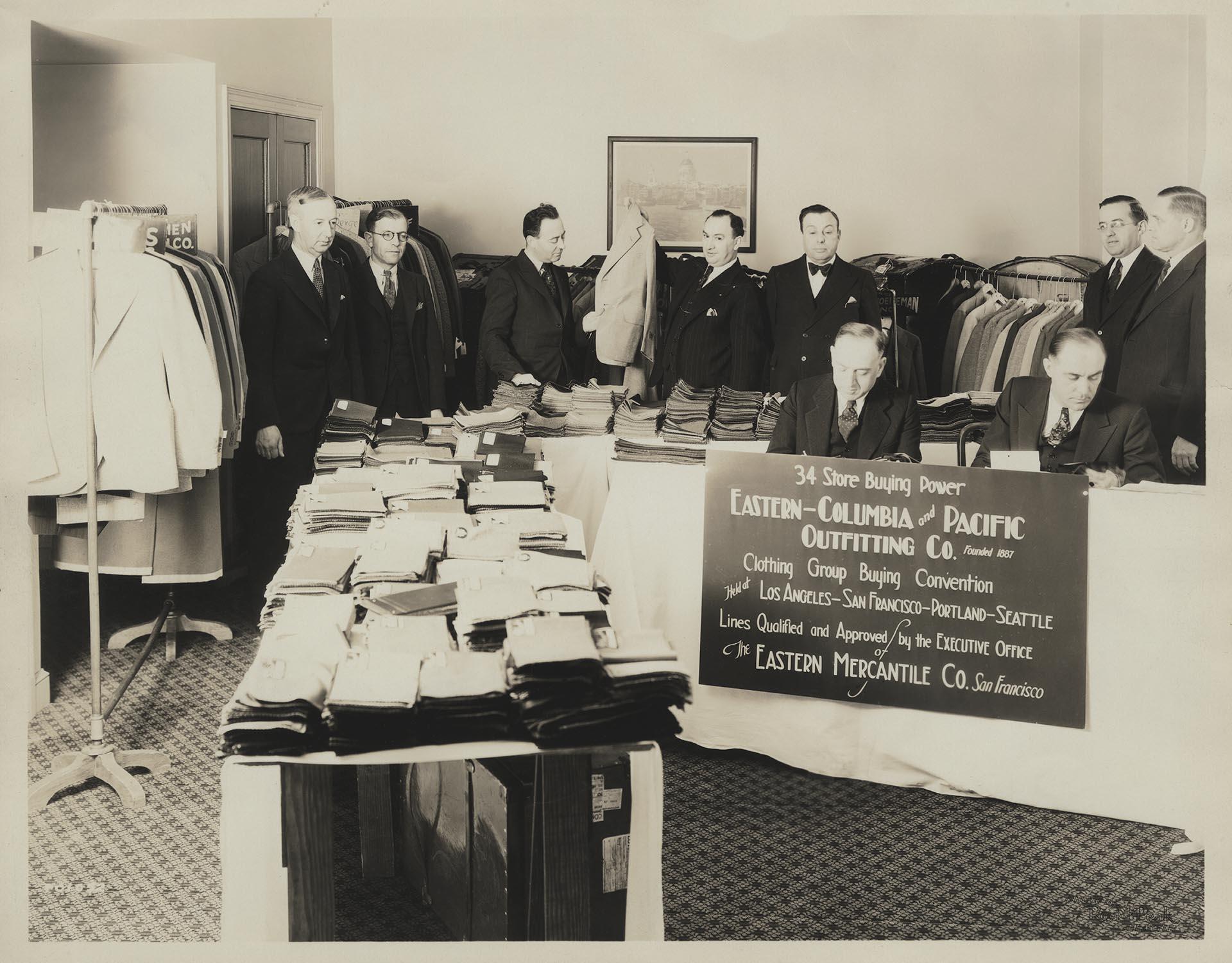 Image of Pacific Outfitting Company clothing display and customers, Seattle, circa 1930