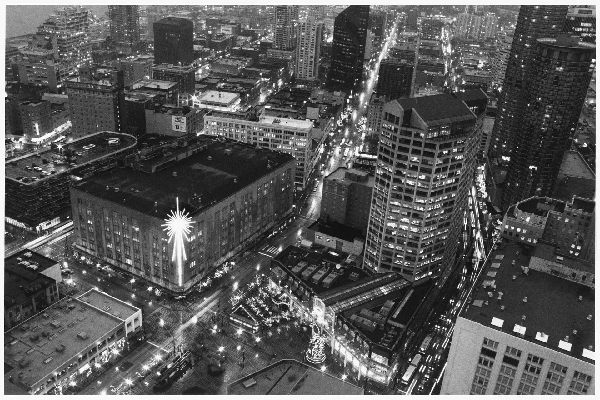 Image of Aerial photograph of Bon Marché with Christmas star and downtown extending east and north, Seattle, circa 1965
