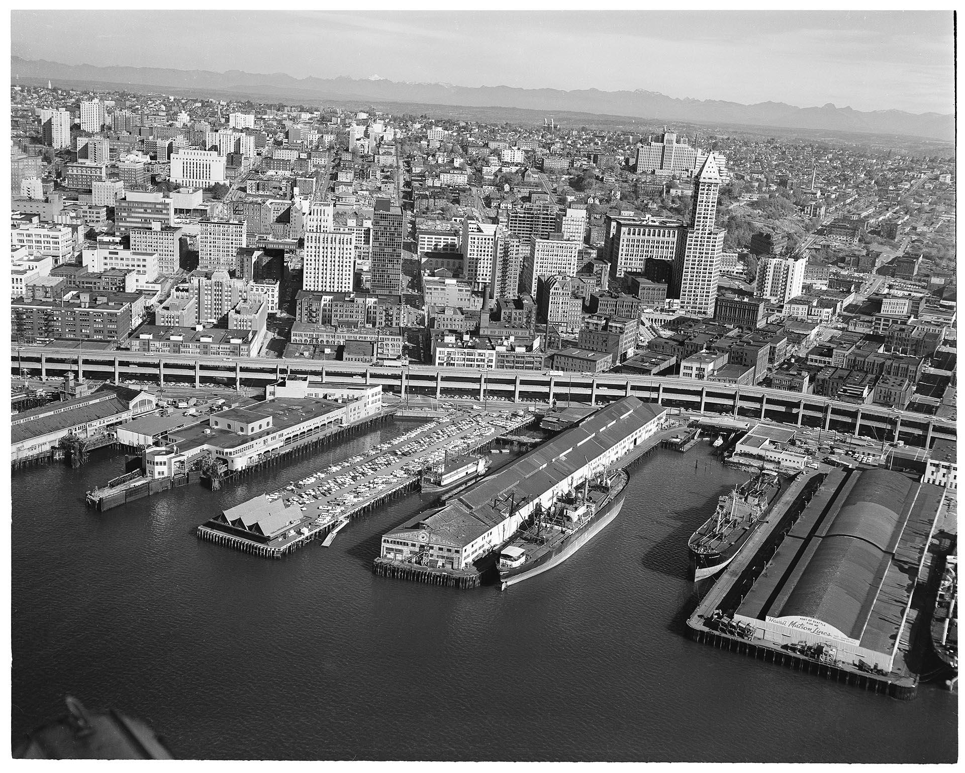 Image of Aerial view of Seattle waterfront, showing Polynesian Restaurant on Pier 51, October 13, 1961